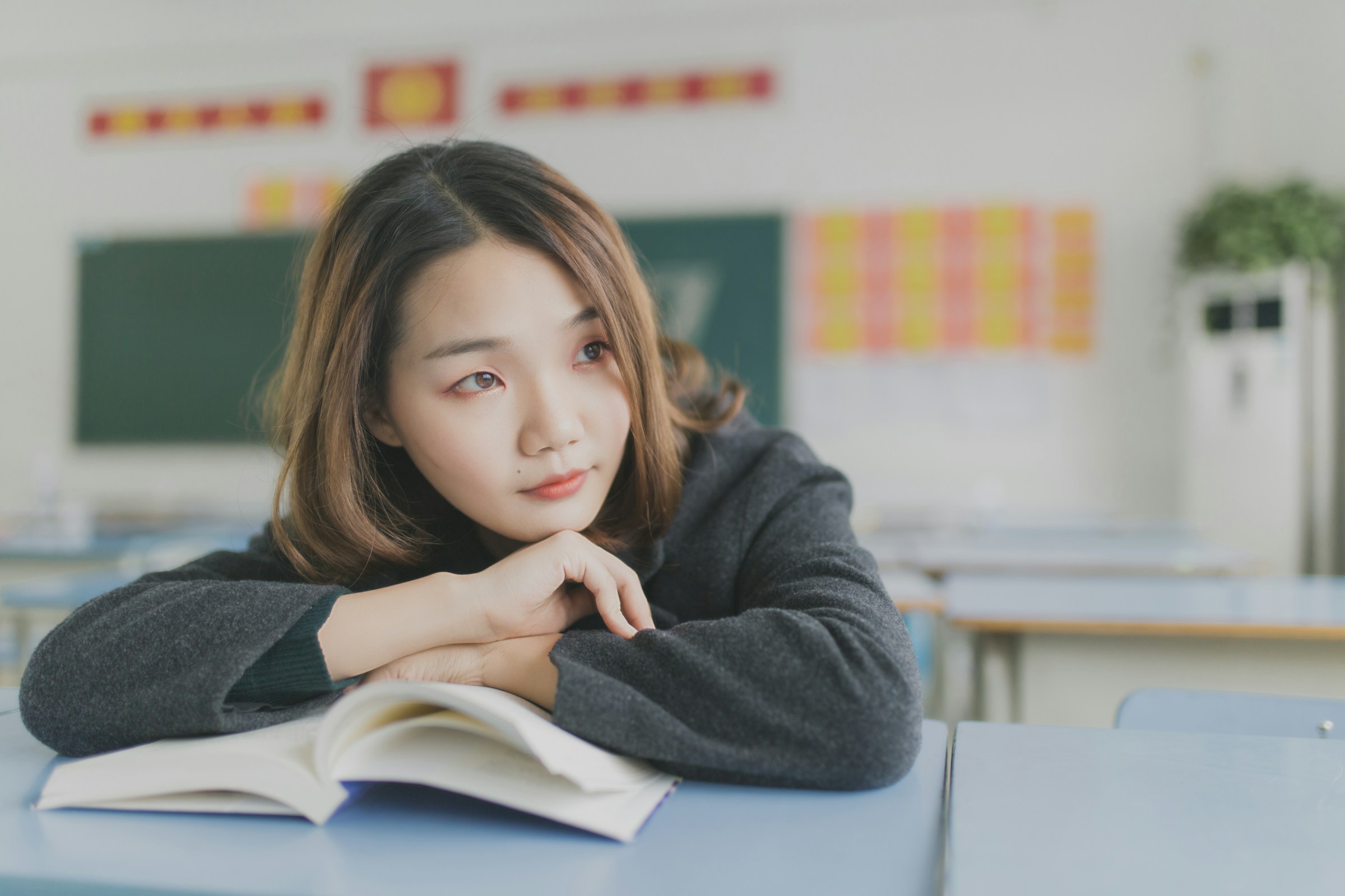 woman sitting alone in class - How To Be A Better Student