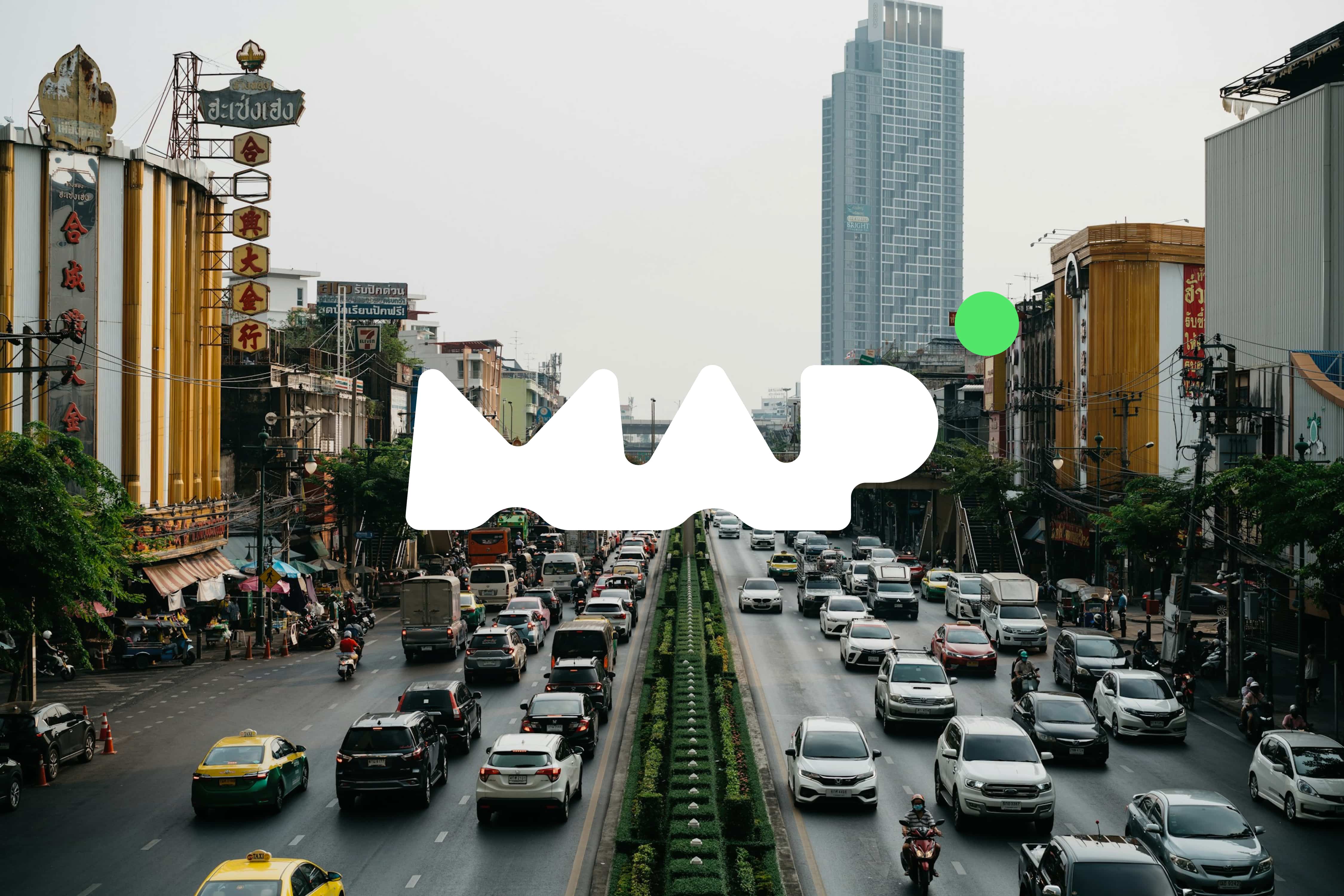 Blurry figure walks past a building with fire escape.