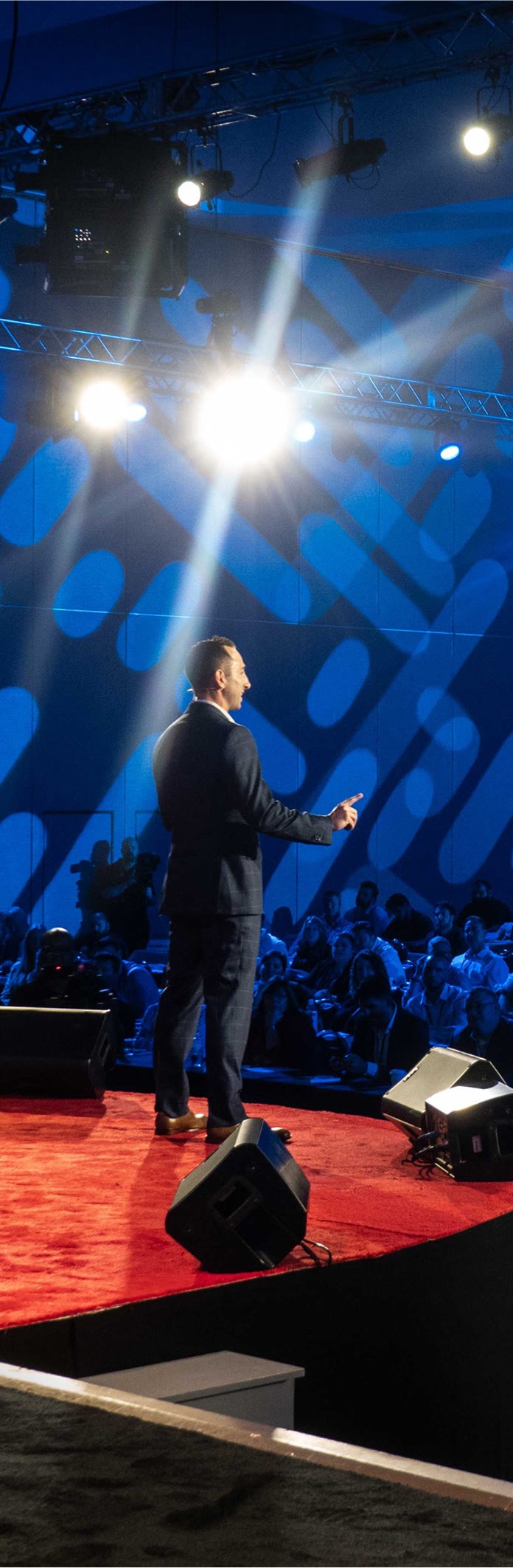 Brandon speaking to an audience at a conference