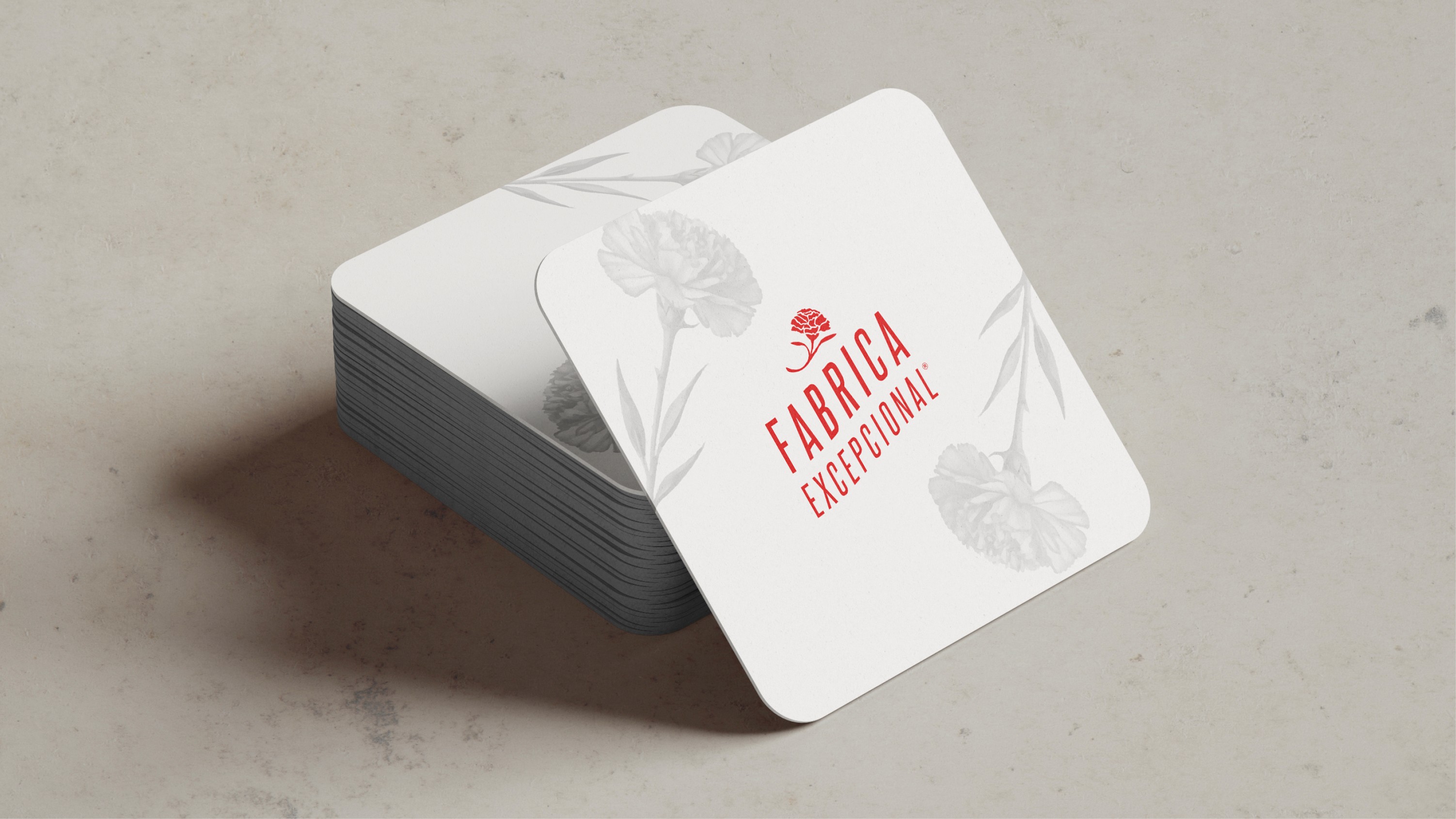 White branded beer coaster featuring the Fabrica Excepcional logo