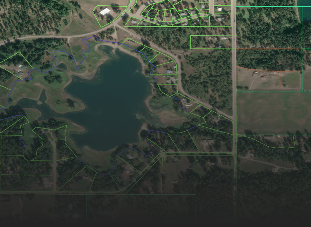 Parcel and boundary outlines over a satellite image of a residential area
