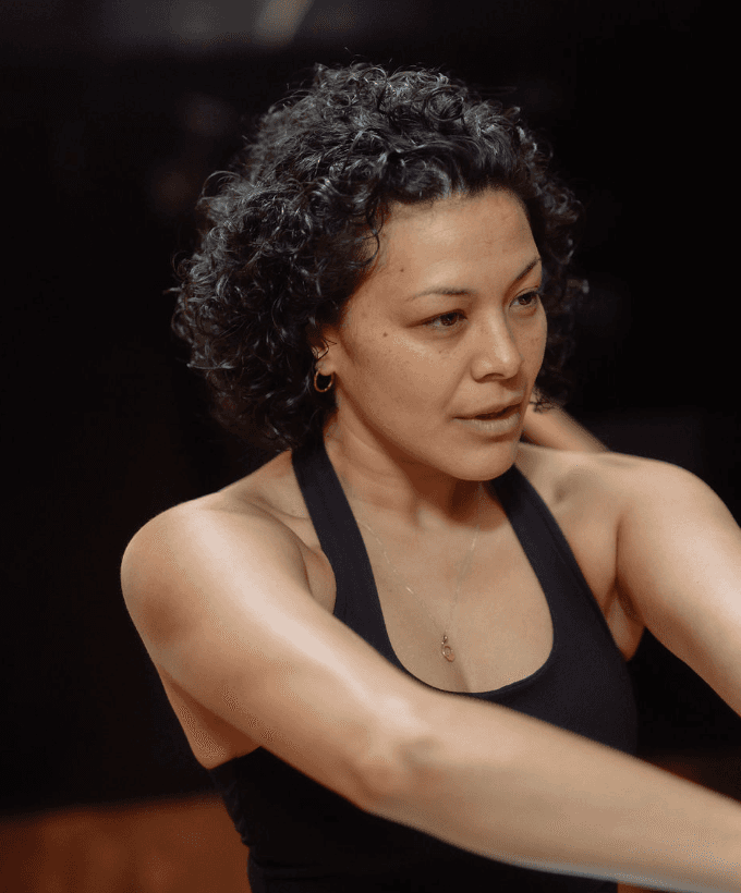 Black cosmetic product bottle against a dark background