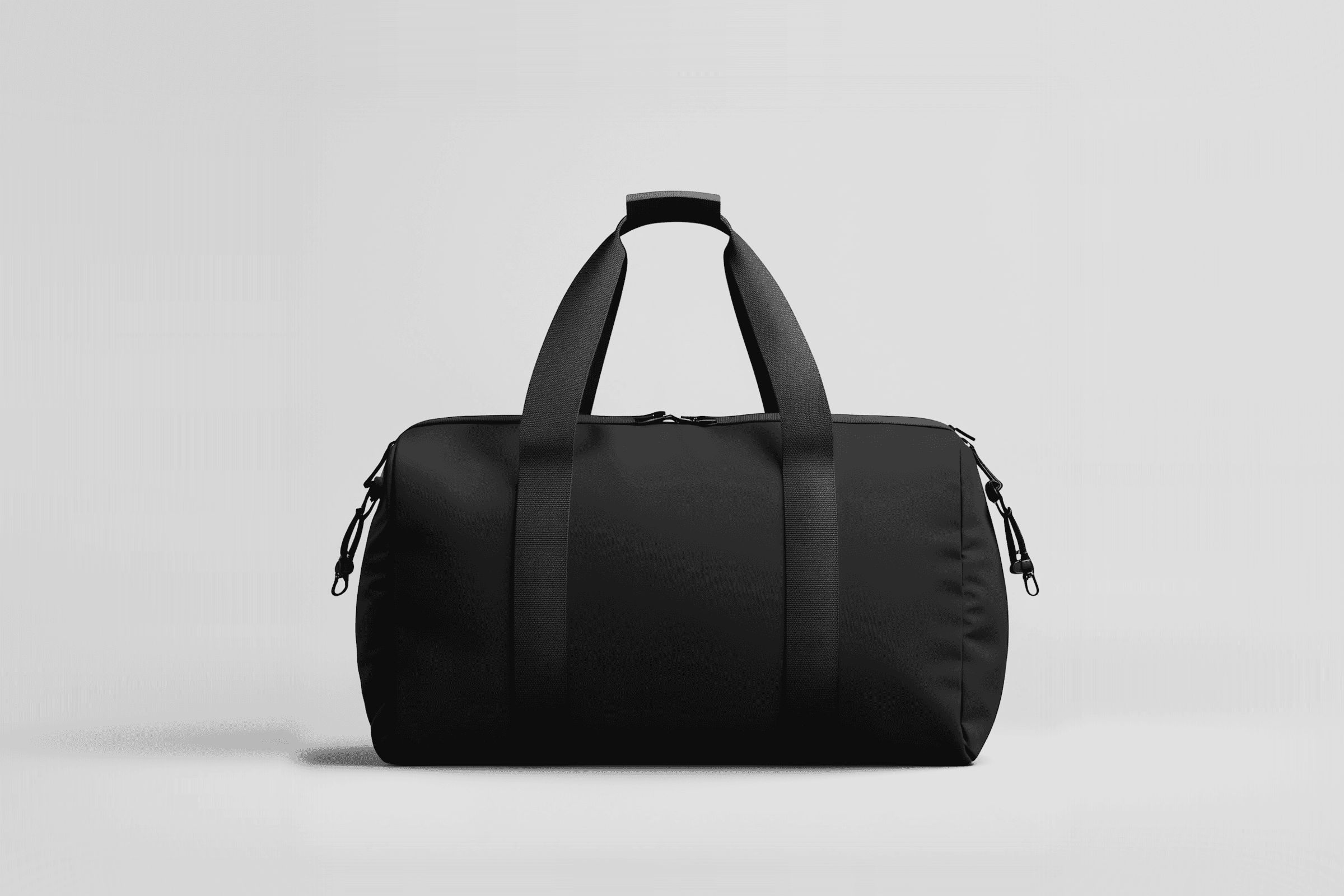 Sleek black duffel bag with sturdy straps and minimalist design on a light gray background. Perfect for travel or gym use.