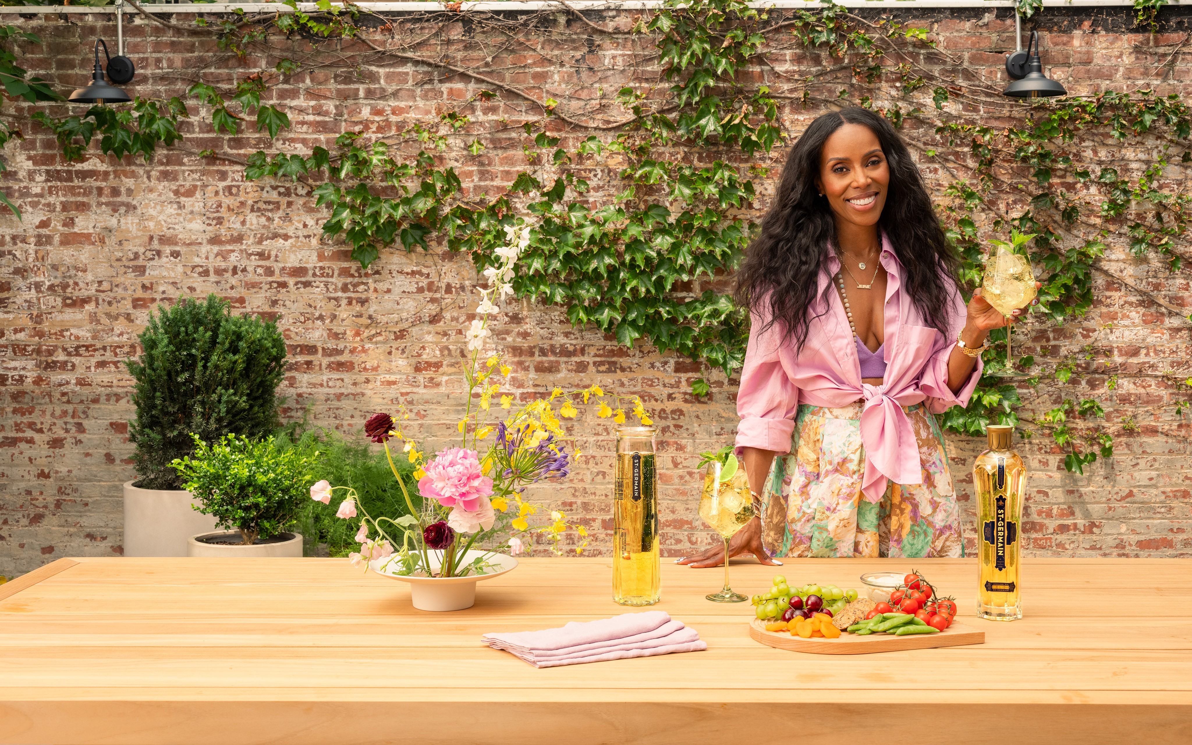 June Ambrose standing behind the full Avant Garden table