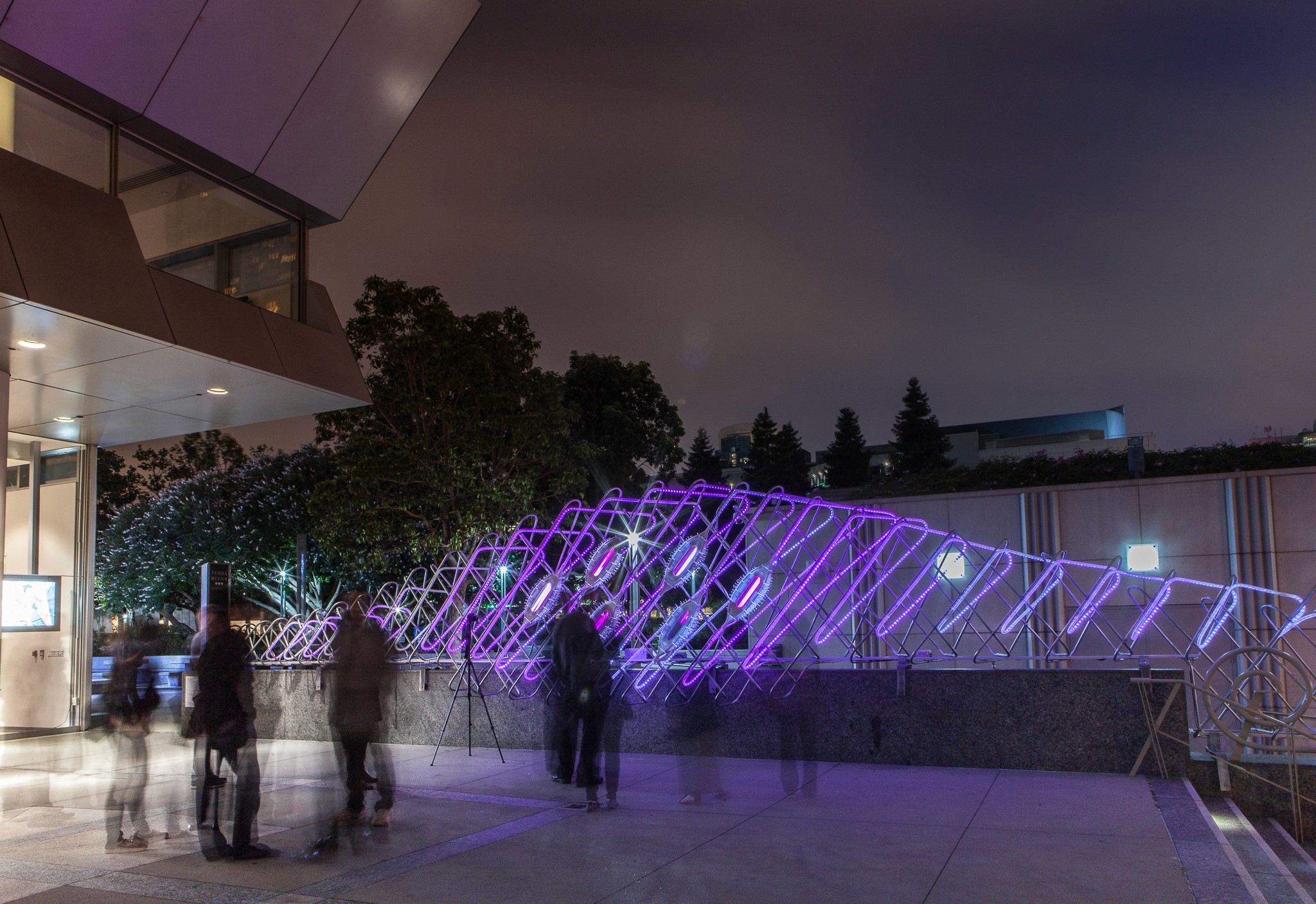 A ballerina with long hair throws her arms up