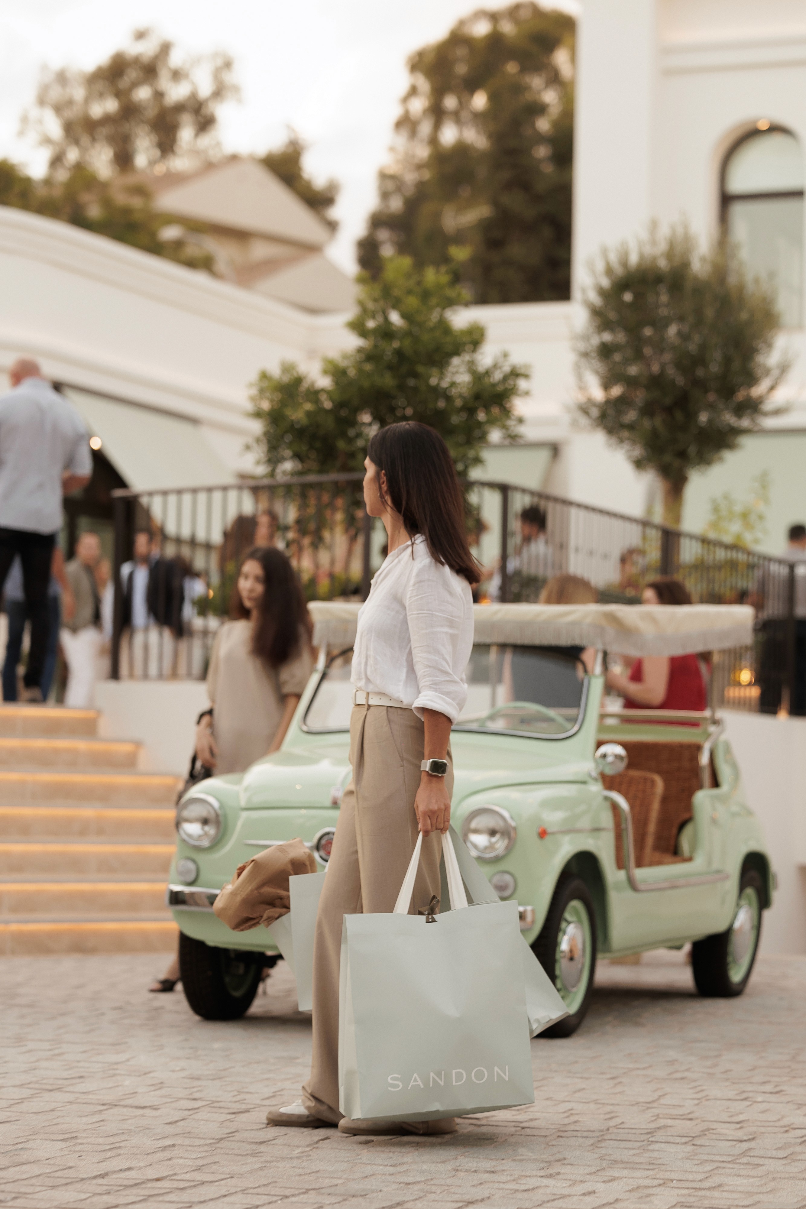 The wedding backdrop is the open sea, shimmering under late afternoon light