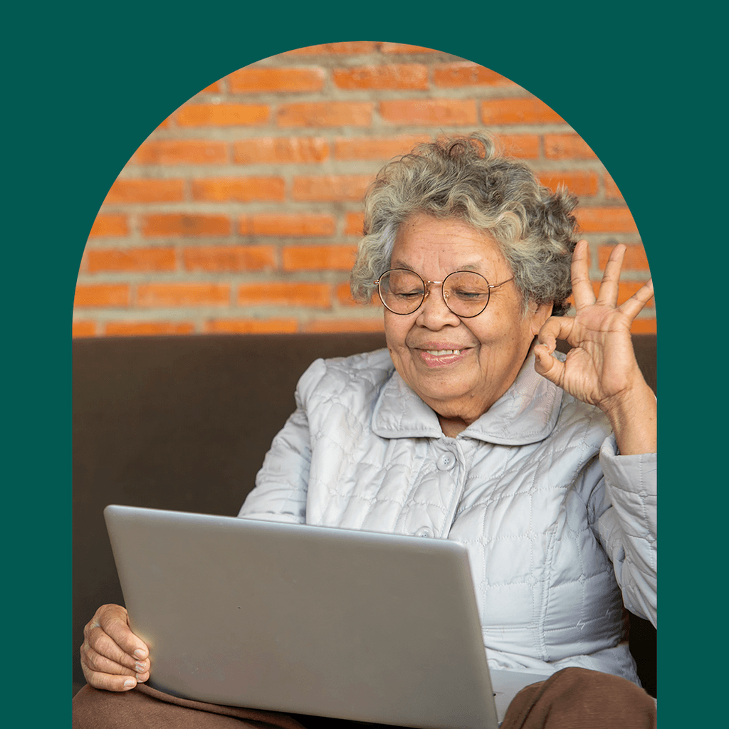 Elderly woman smiling and signing OK