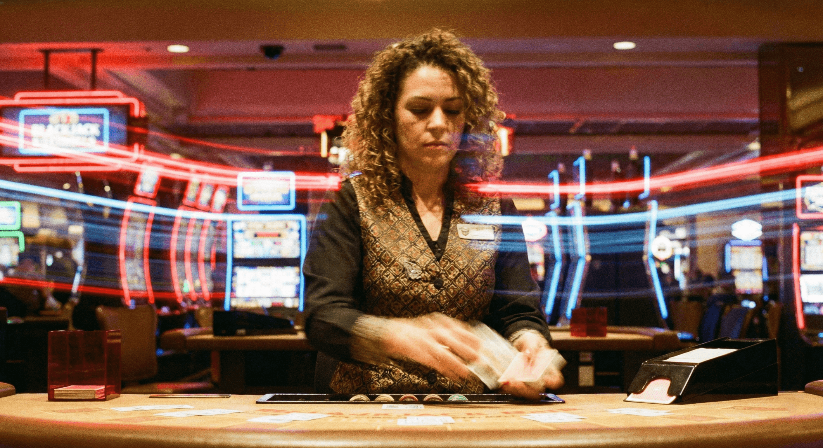 A blackjack dealer dealing a hand at a casino