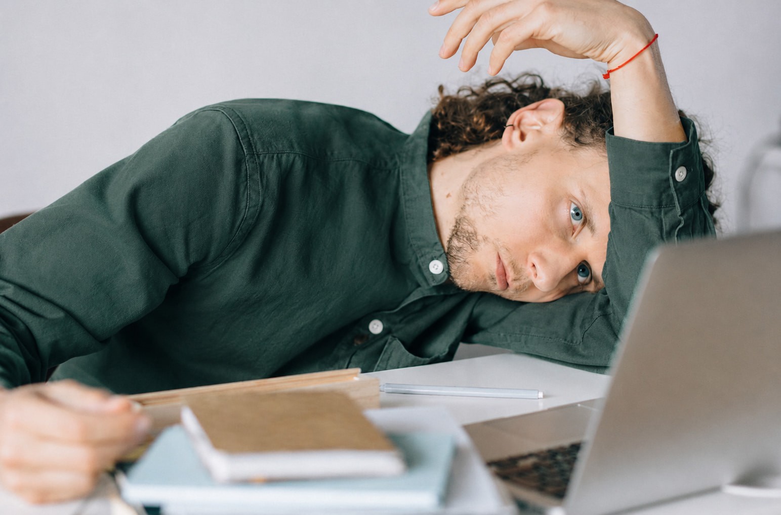 Exhausted man overwhelmed by hesitation and fear while avoiding important decisions