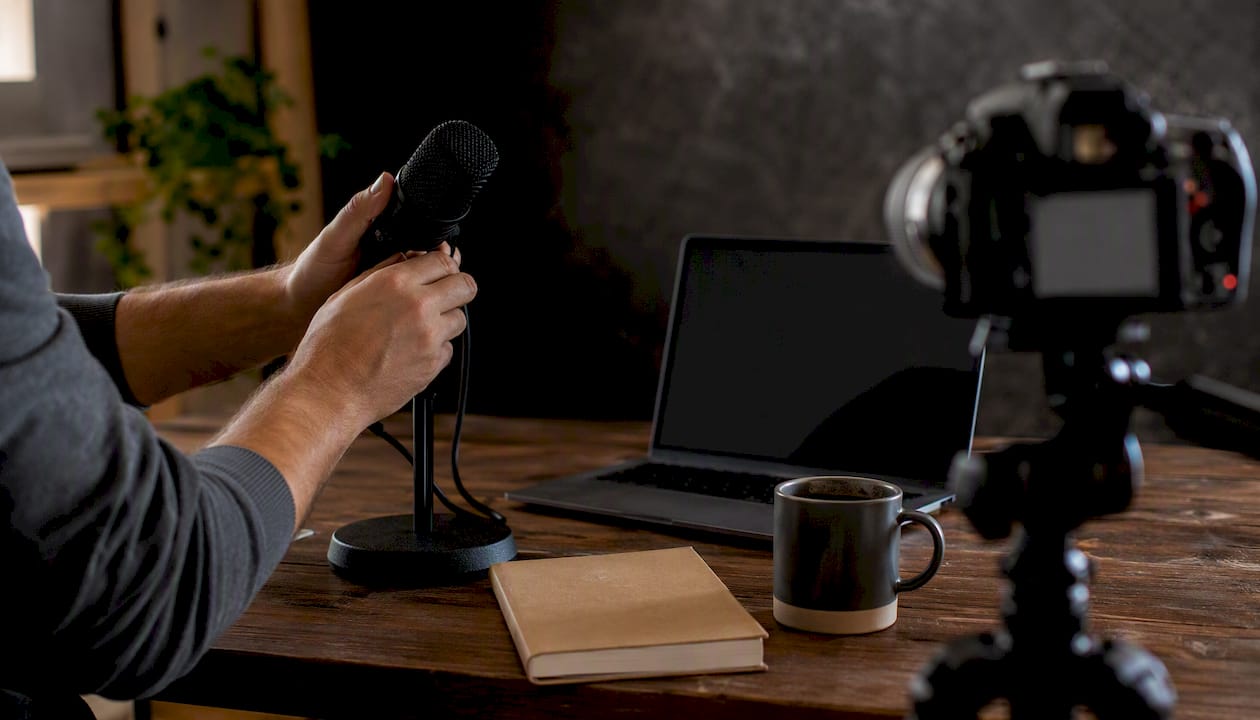 Hands holding microphone in video demo setup