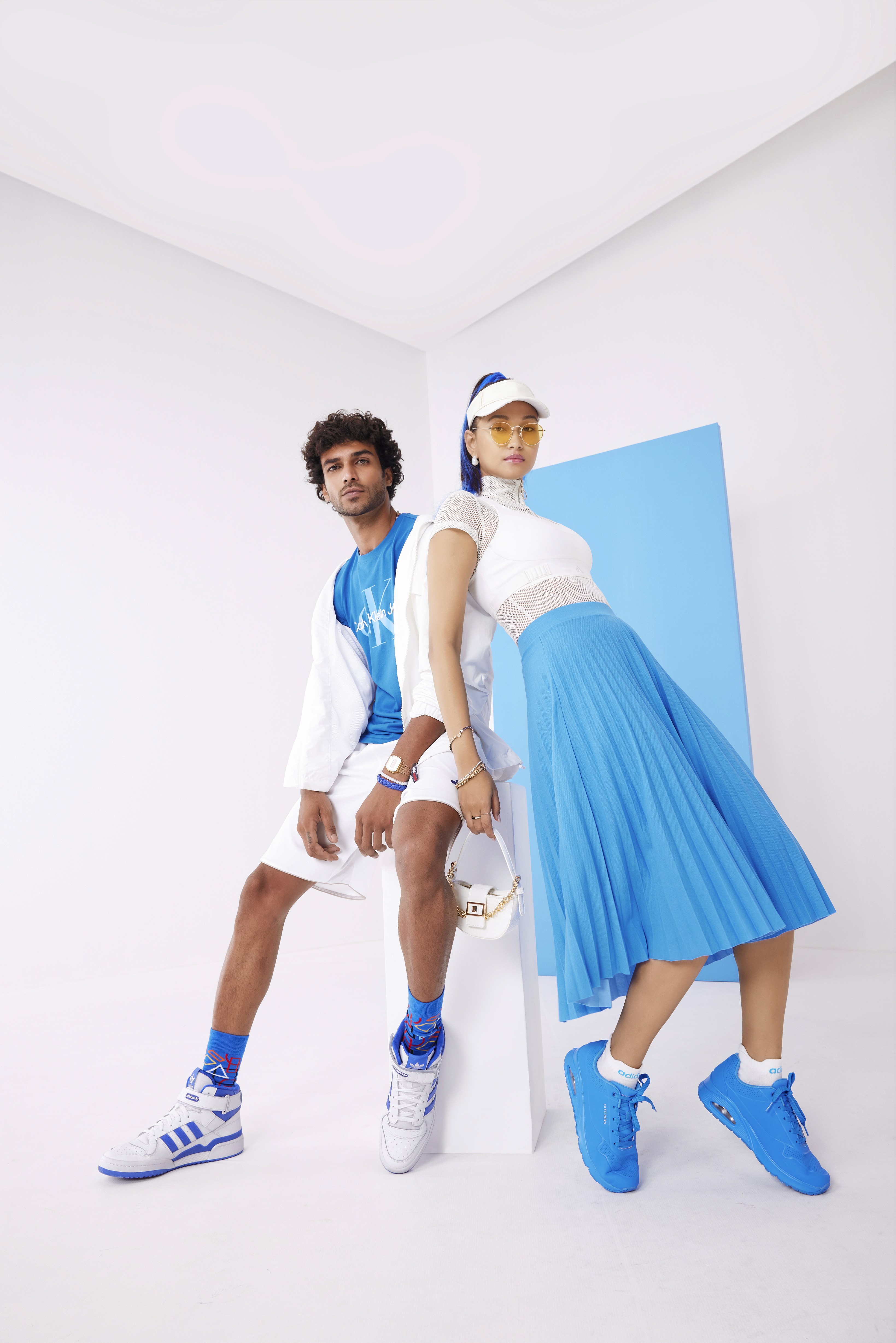 People playing soccer on a rooftop court surrounded by city buildings