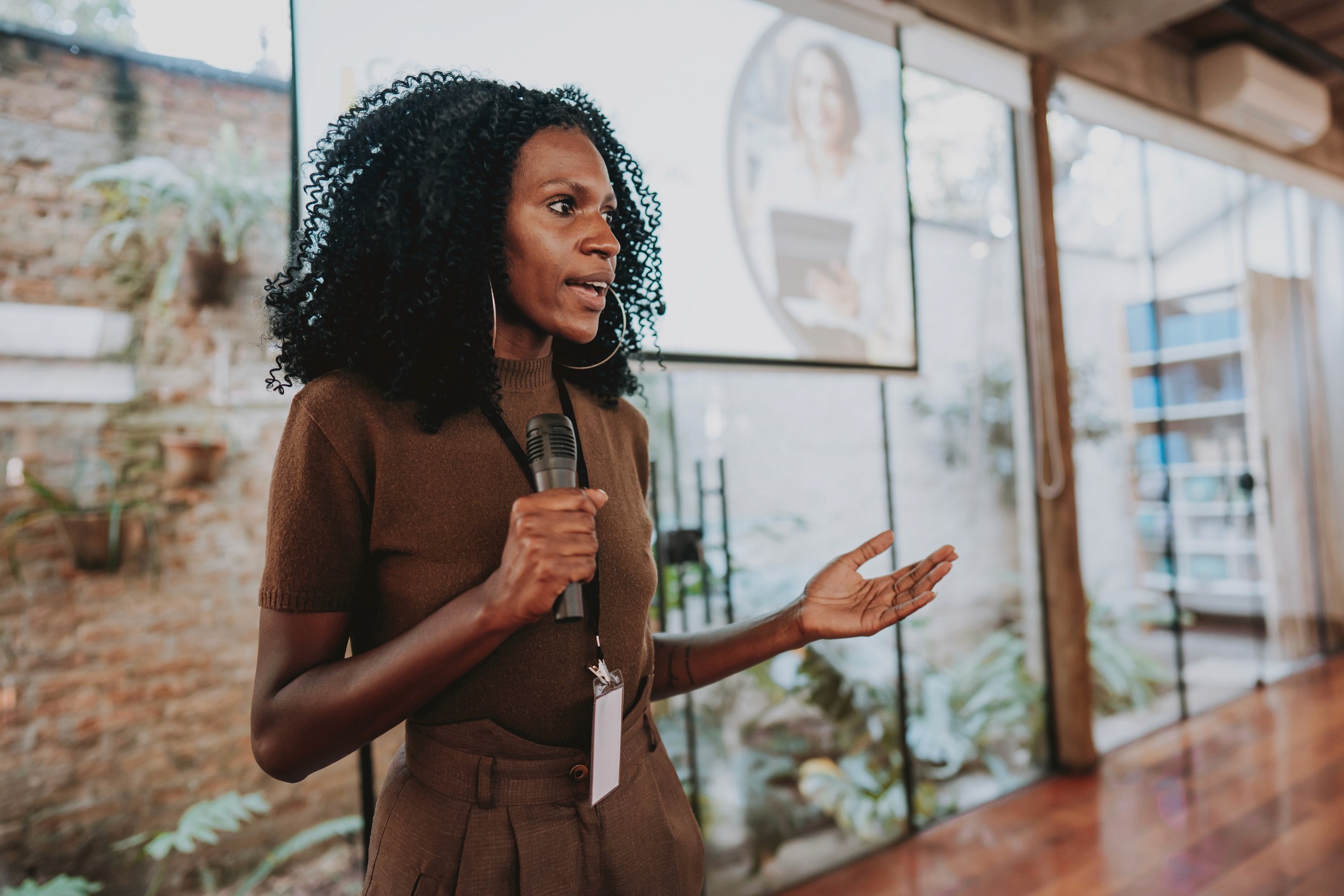 FoundHers - Our Focus - Black Woman Speaking in Brown Shirt