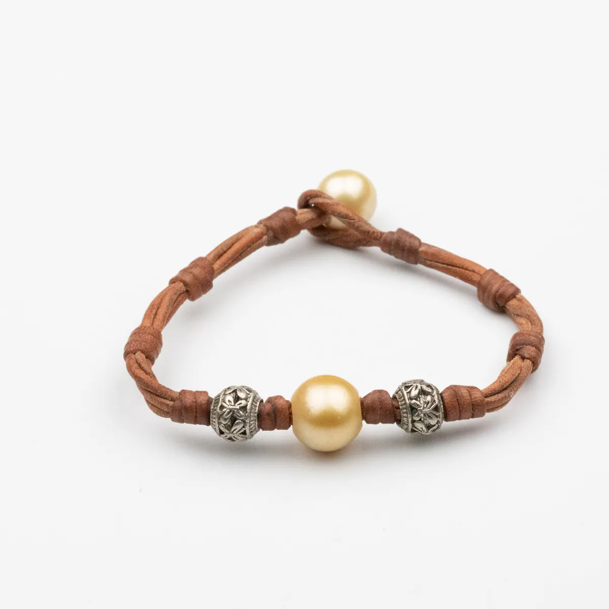 Golden South Sea Pearl leather bracelet with carved silver beads and pearl closure on brown leather cord — Manos de Oro Saint Barth