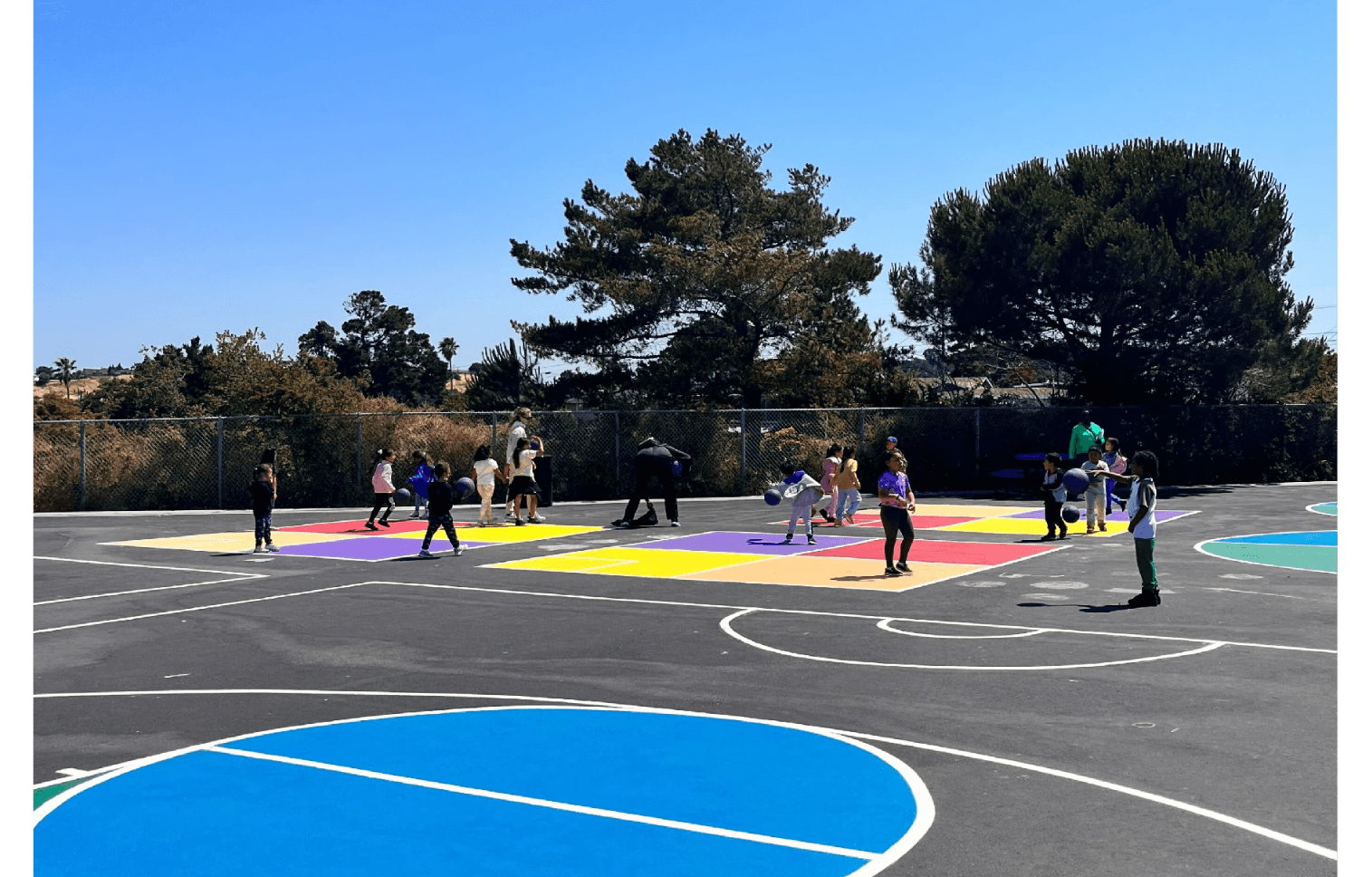 After-school educator supporting students during structured outdoor play as part of a HOKALI enrichment program.