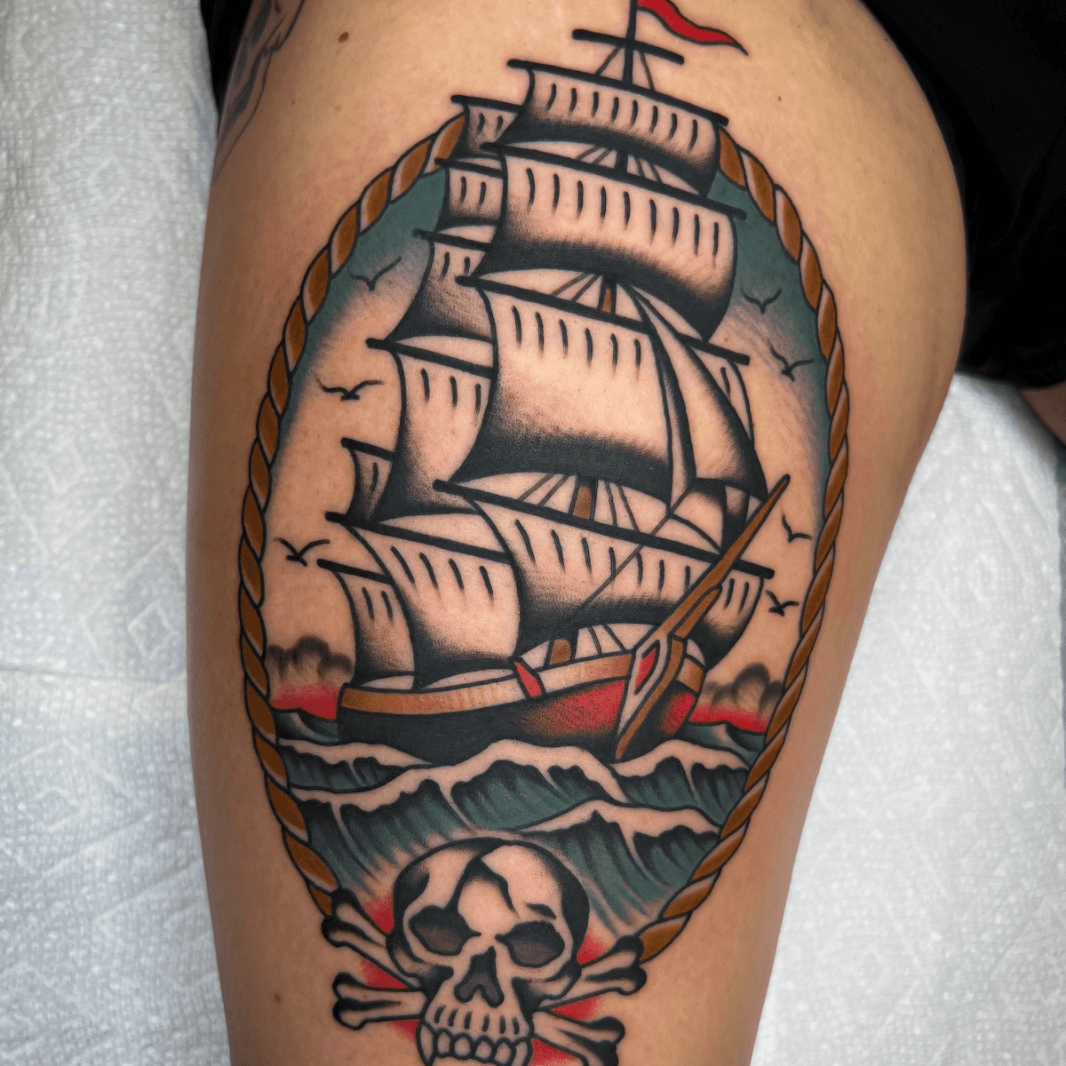 large color tattoo of a clipper ship with a skull