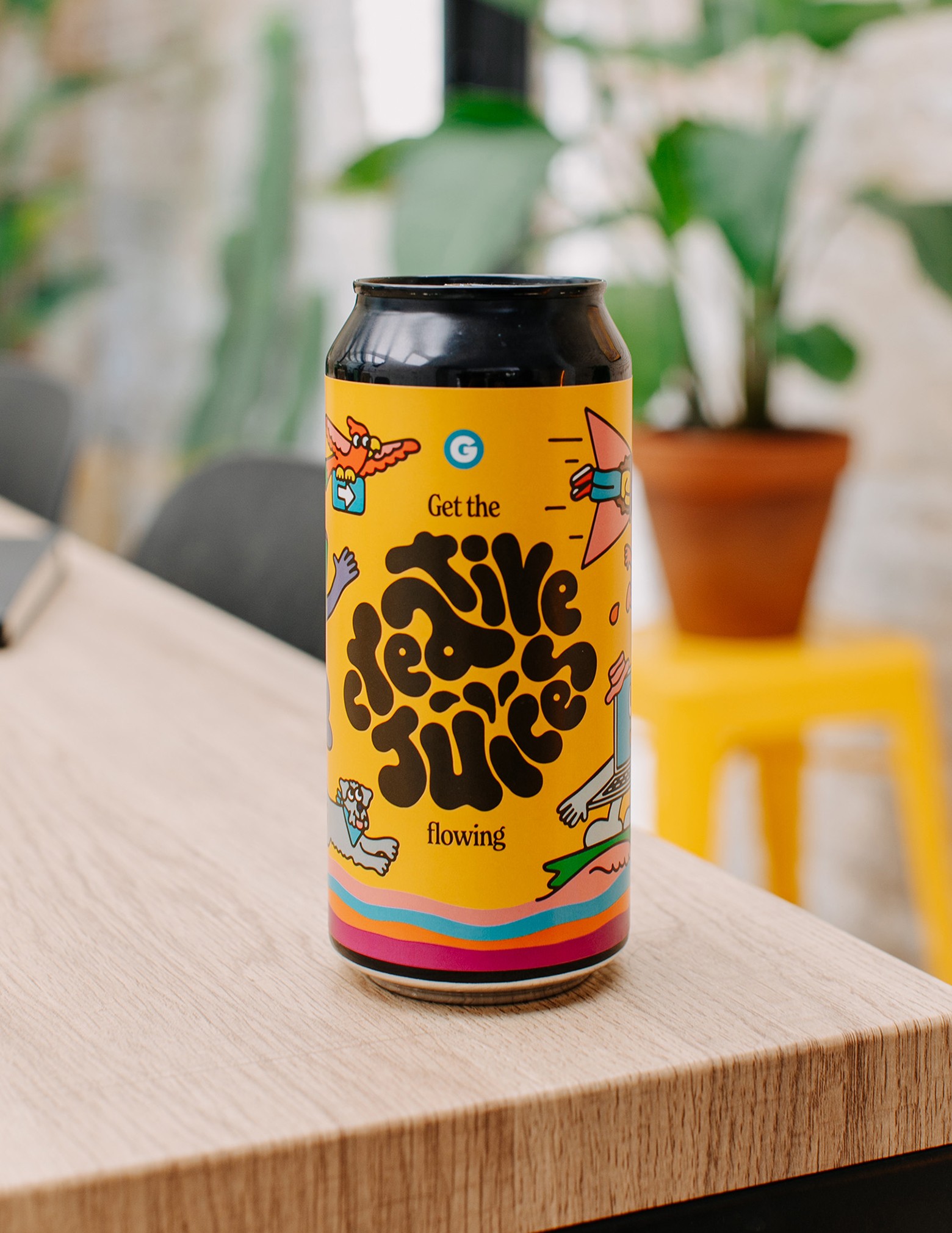 A woman holding a custom beer standing on a furniture