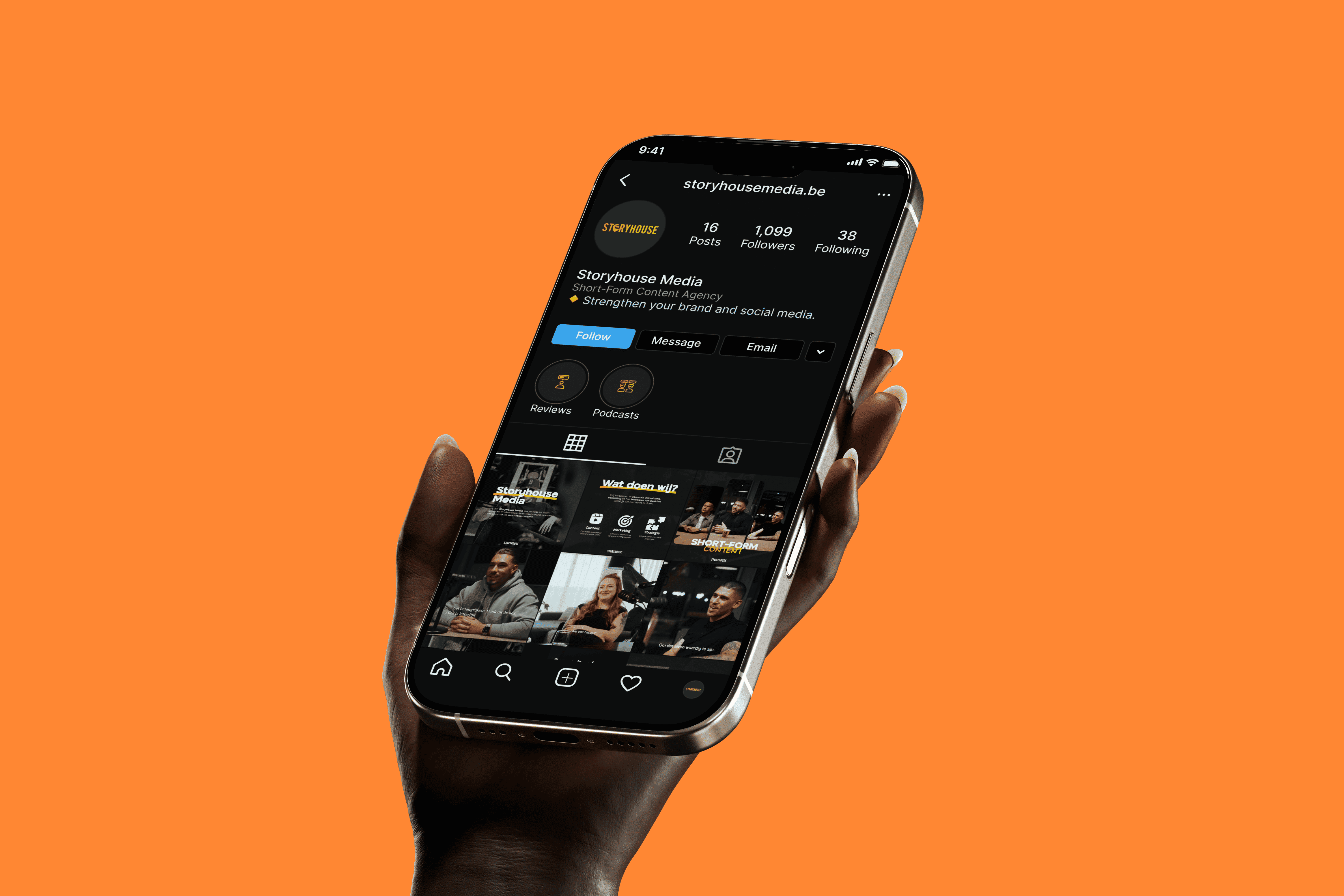 Hand holding a smartphone displaying the Storyhouse Media Instagram profile and content grid.