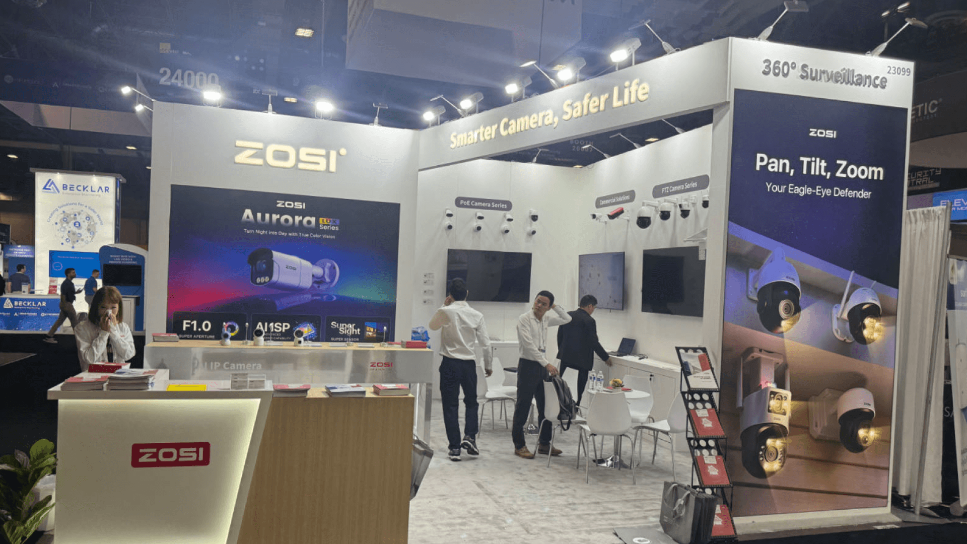 ZOSI ISC West 2024 20x20 booth at Venetian Expo — PTZ pan-tilt-zoom feature panel supporting live video surveillance demos and cable-managed install