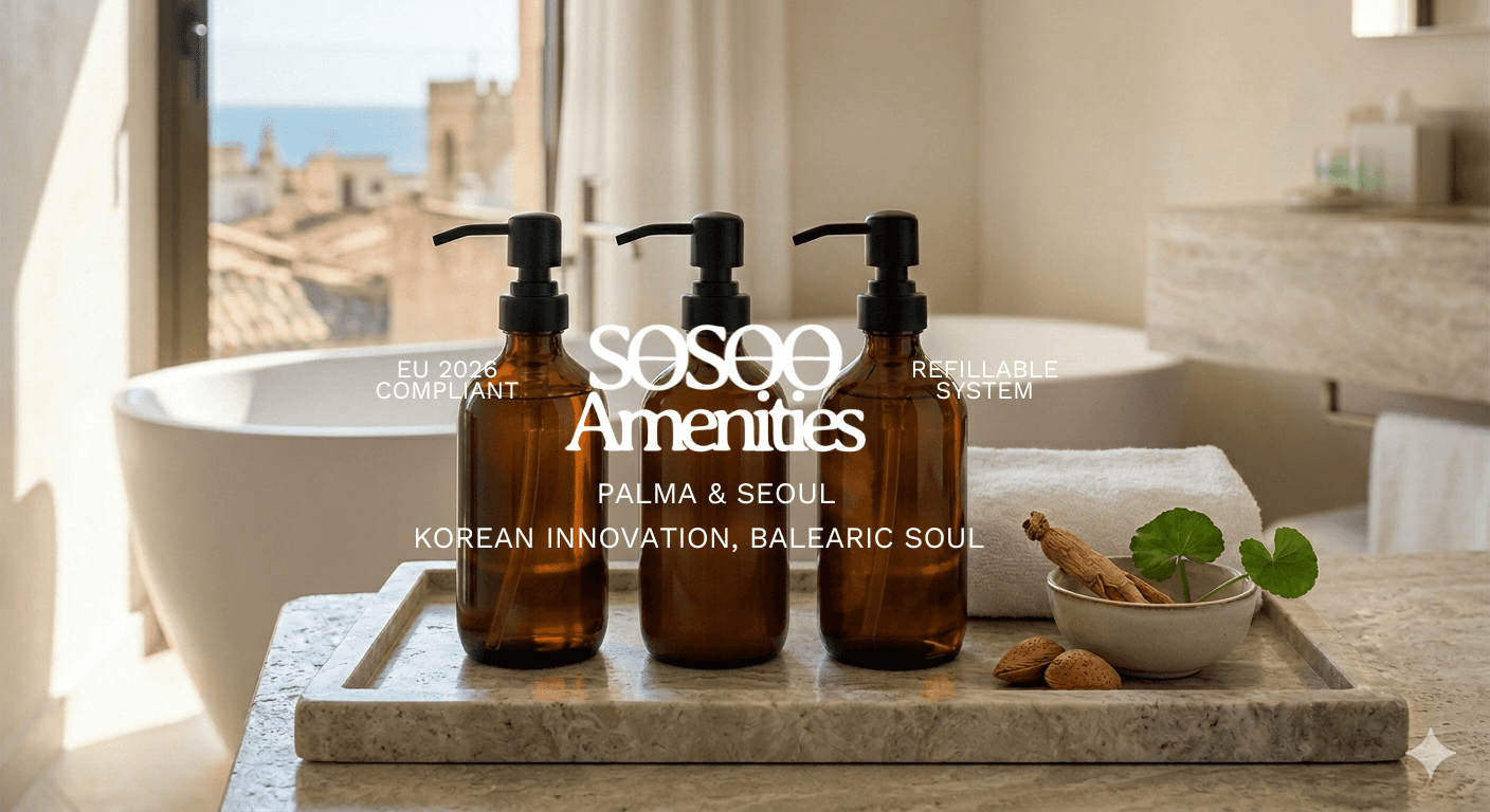 A minimalist luxury hotel bathroom with natural light, featuring three empty amber glass pump dispensers on a large stone tray. Raw Korean botanicals and local Balearic almond shells sit in a bowl beside the dispensers, with a blurred view of Palma de Mallorca outside the window