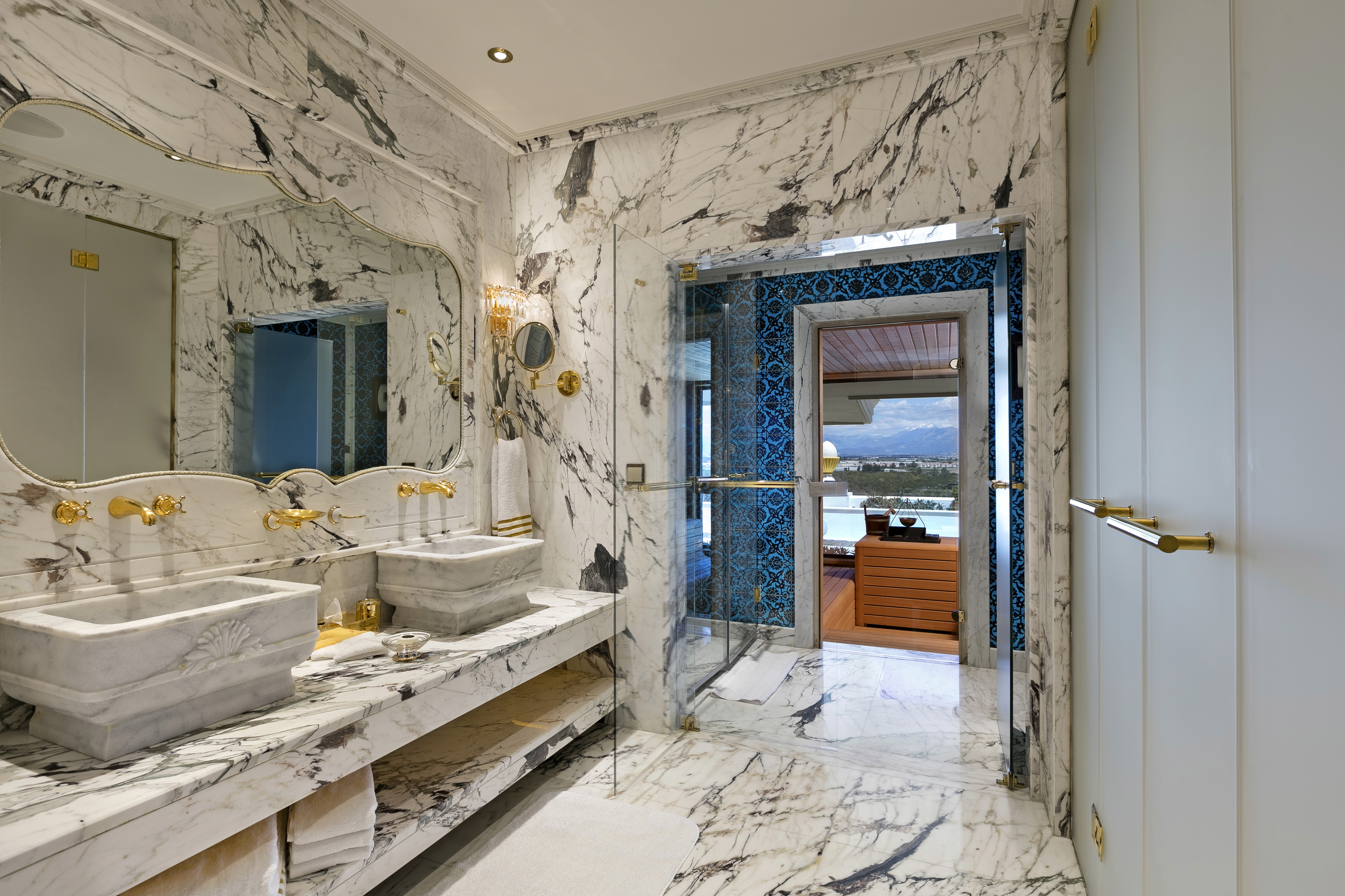 Opulent marble bathroom with jacuzzi, premium amenities, and a spa-like experience.