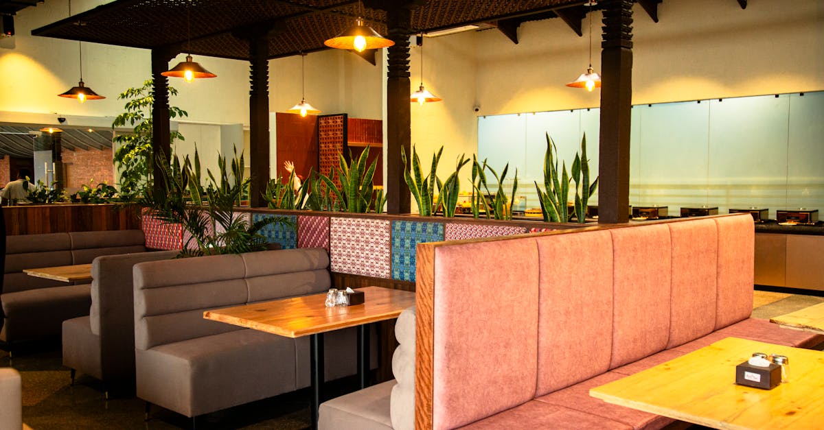 Warm, inviting restaurant interior showing empty booths and vibrant decor.
