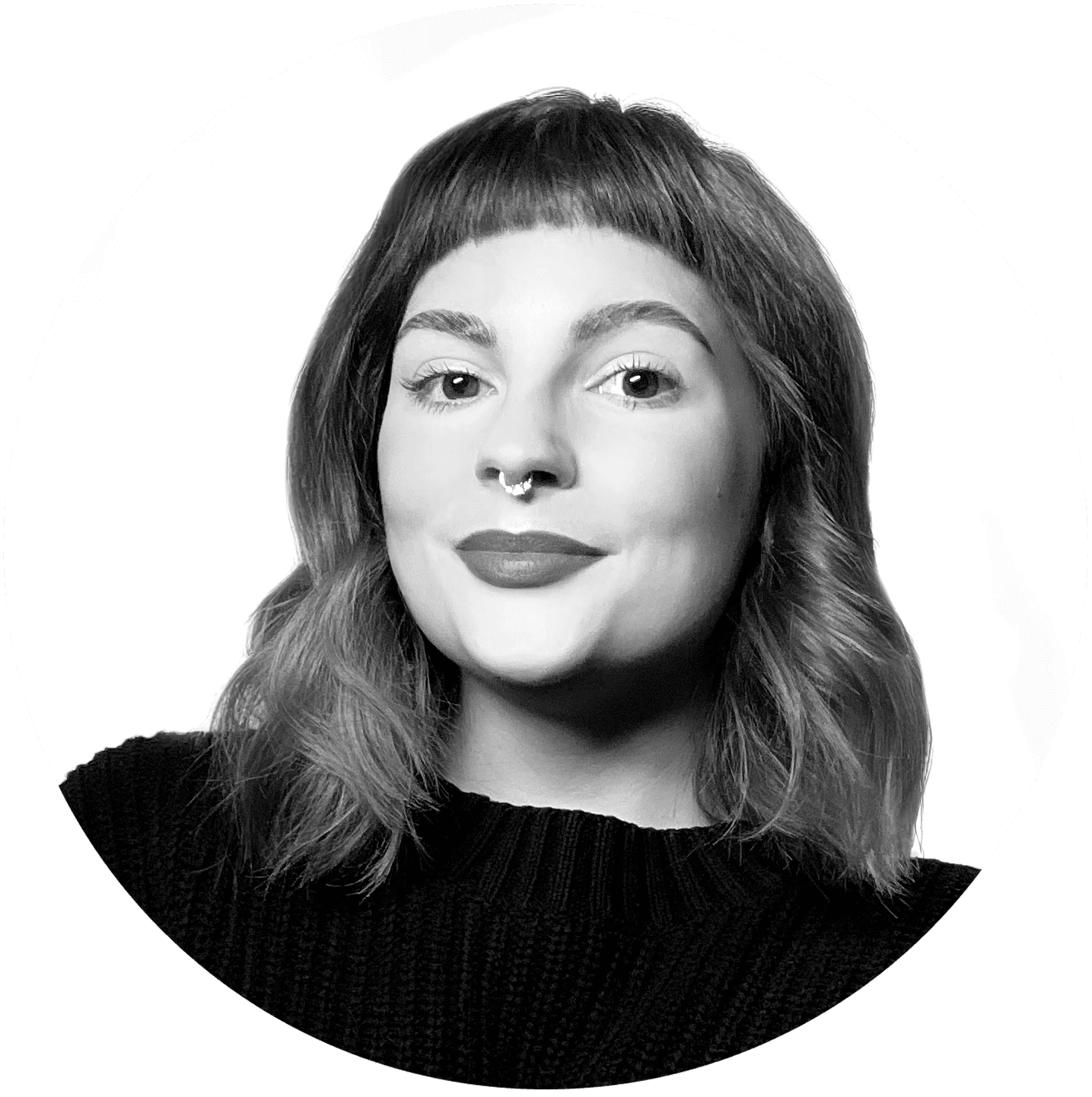 A thoughtful young person with dark hair gazes to the side, captured in soft black and white lighting.