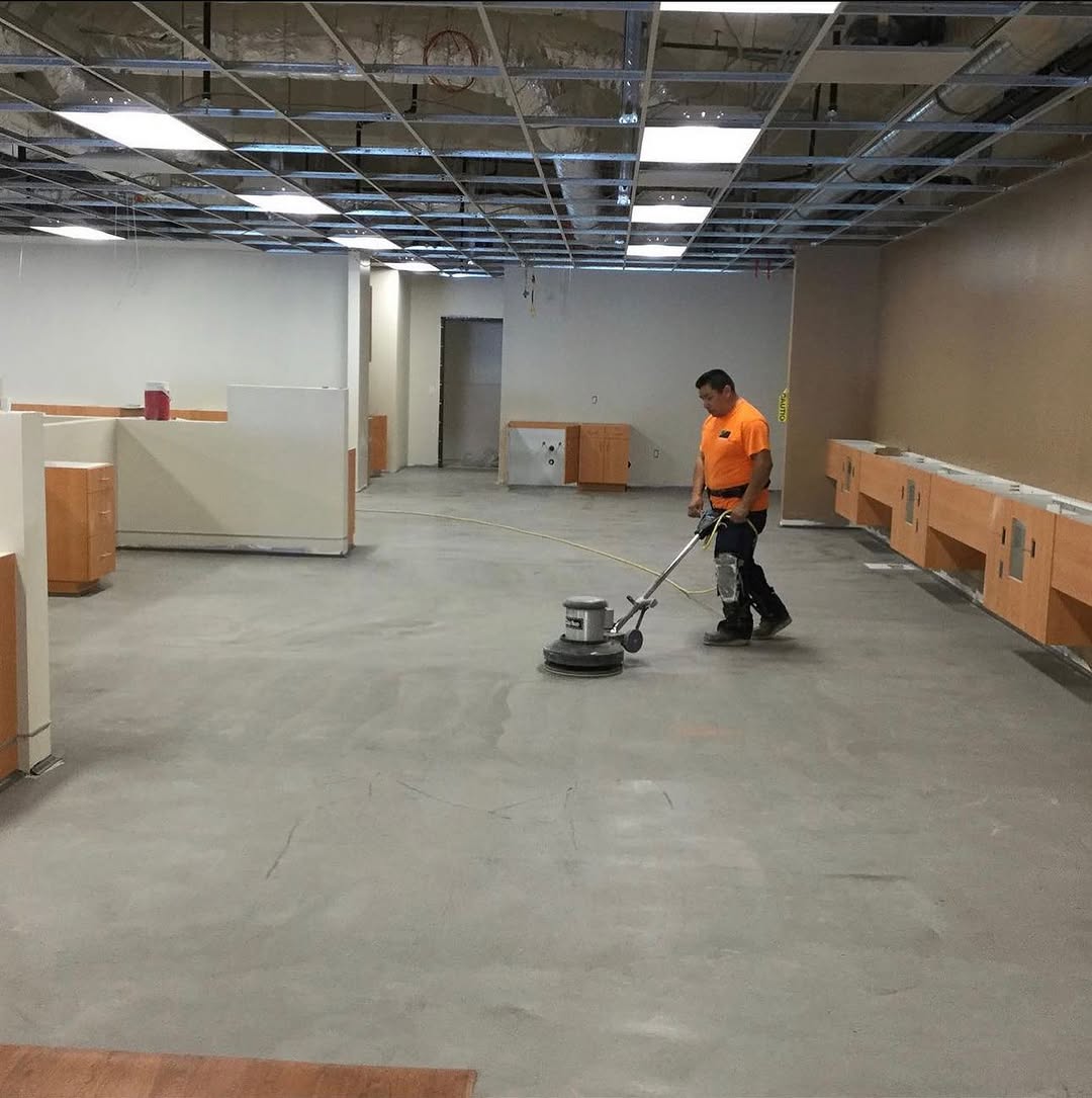 Installer machine-buffing a clinic slab before laying sheet vinyl