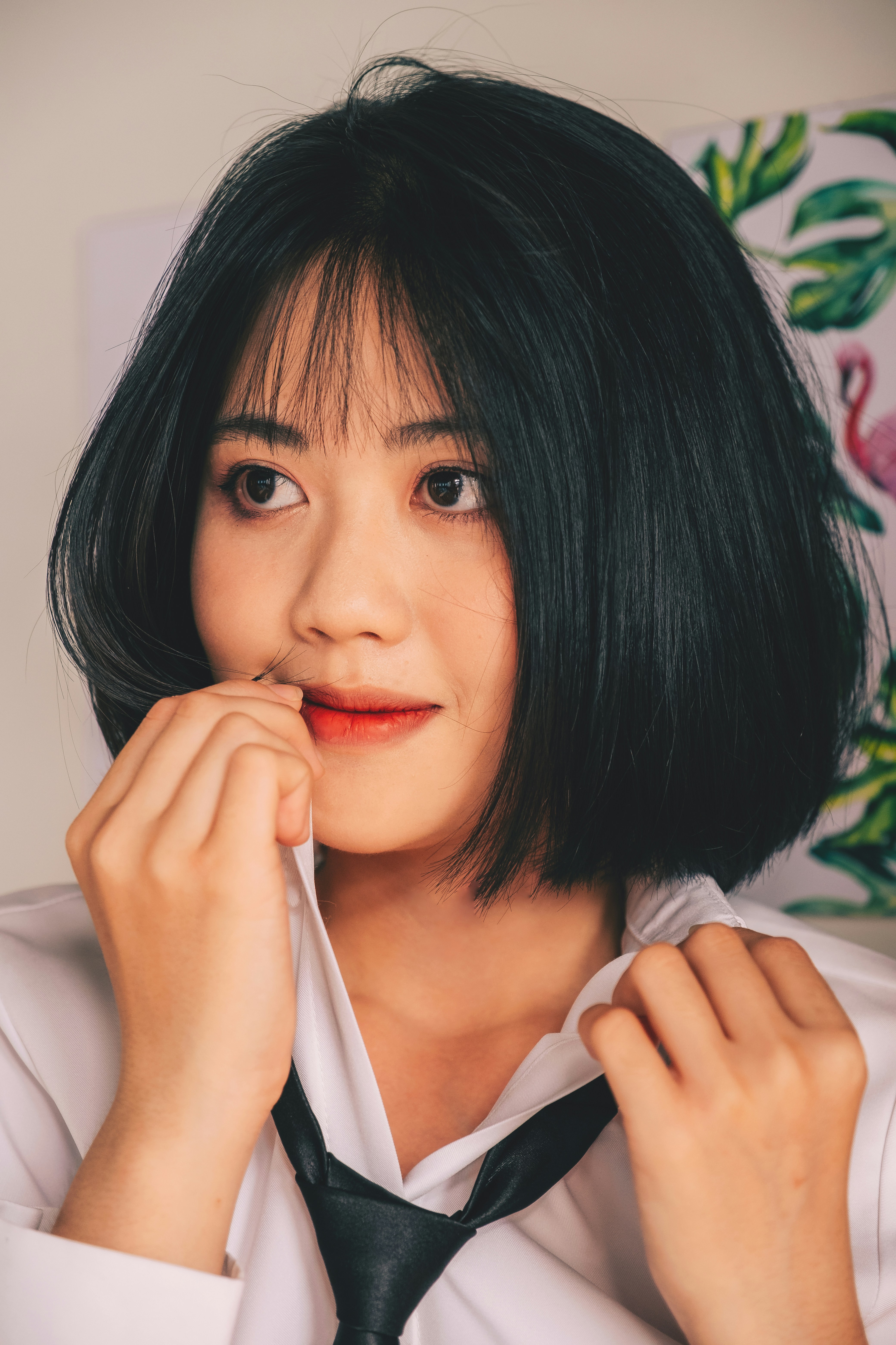 a woman wearing a white shirt and a black tie
