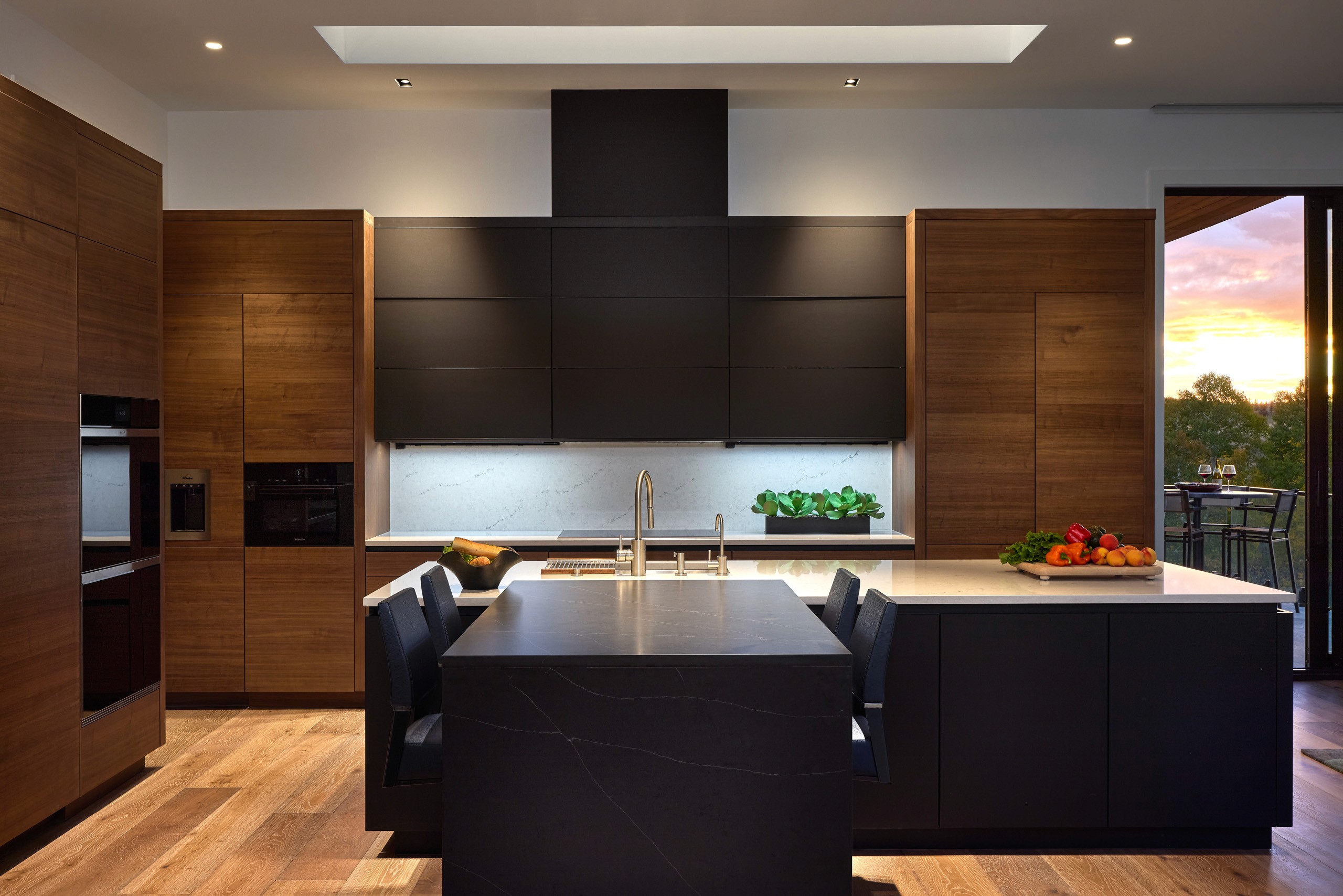Luxury modern kitchen with wood and black cabinetry.