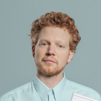 A person with long hair holding a card.