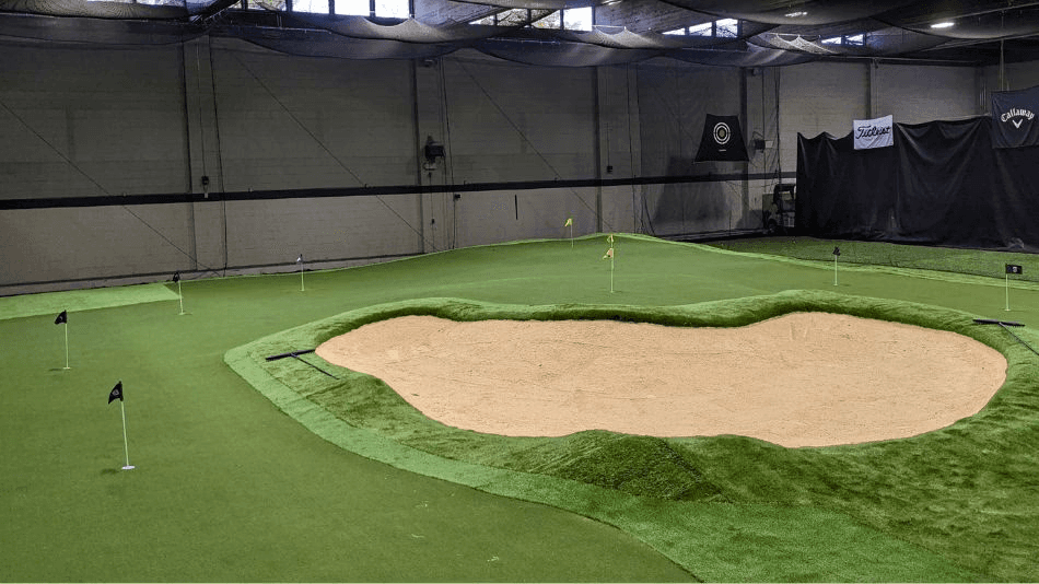 white and green boat on water near white concrete building during daytime
