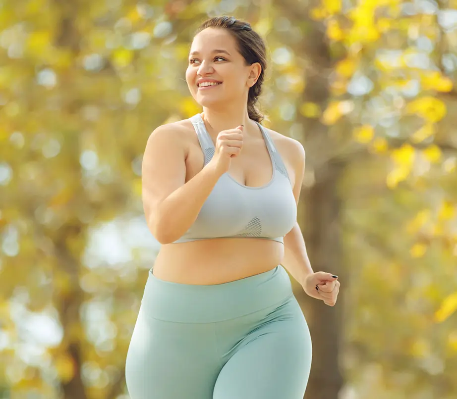 Woman running outodoors with colorful trees and leafs 