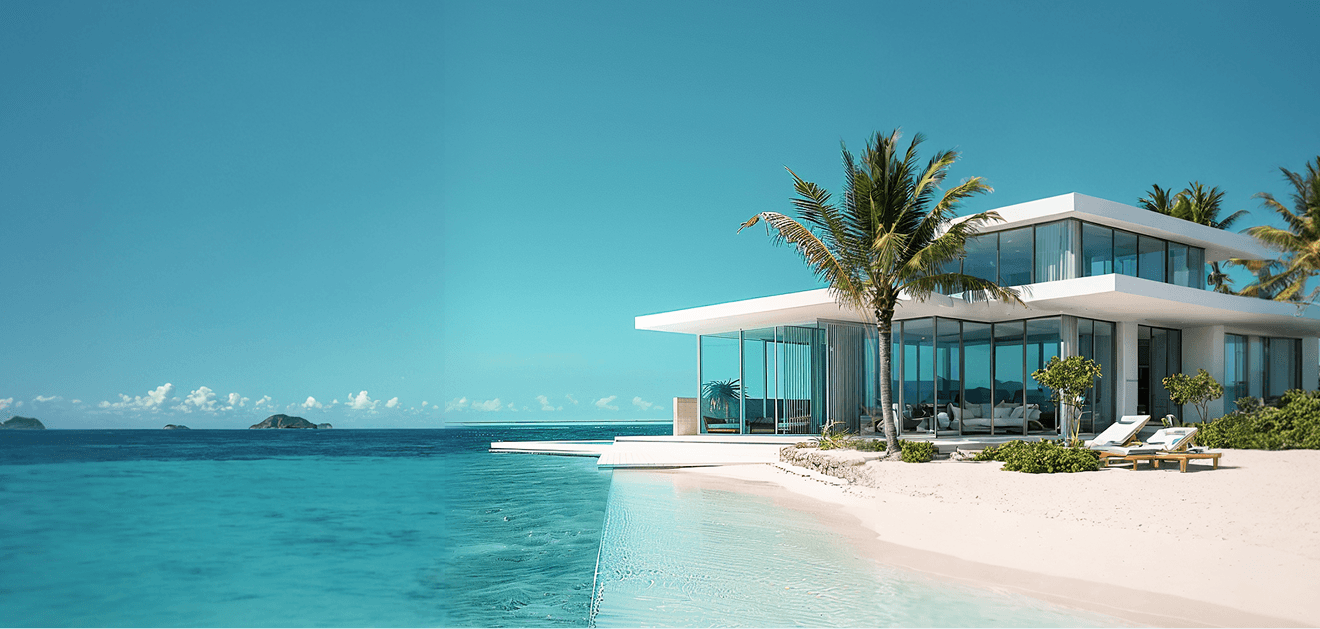 A white house on the beach surrounded by palm trees, with a clear blue sky in the background.