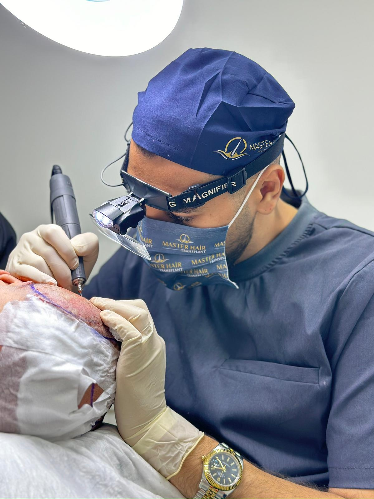 Picture with best hair transplant specialist Mehmet Emin Koldan with patient and nurse.