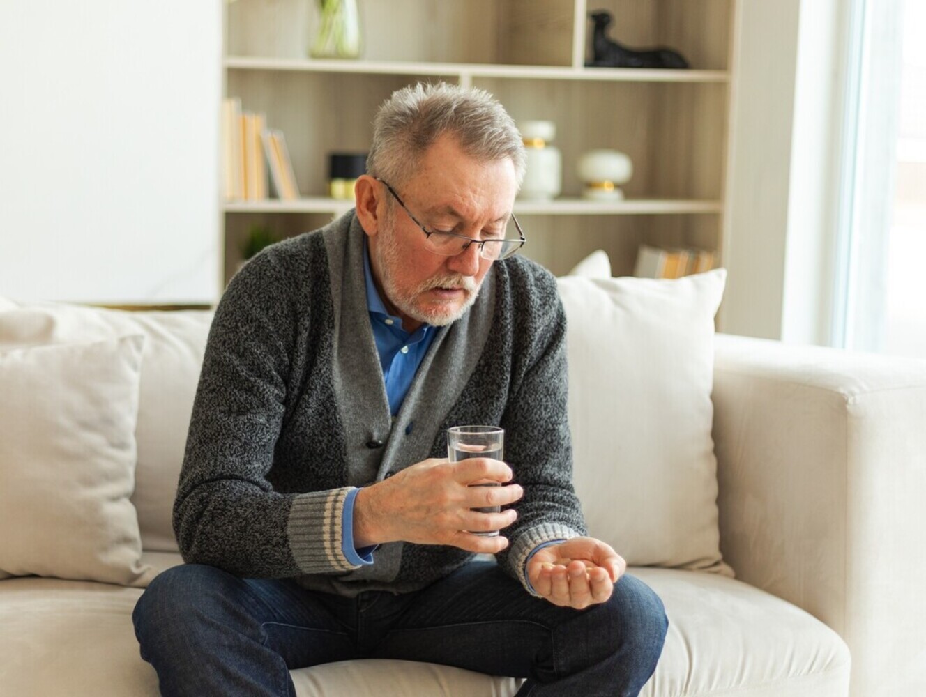 senior man taking one of the most common weight loss drugs that has been approved by his doctor