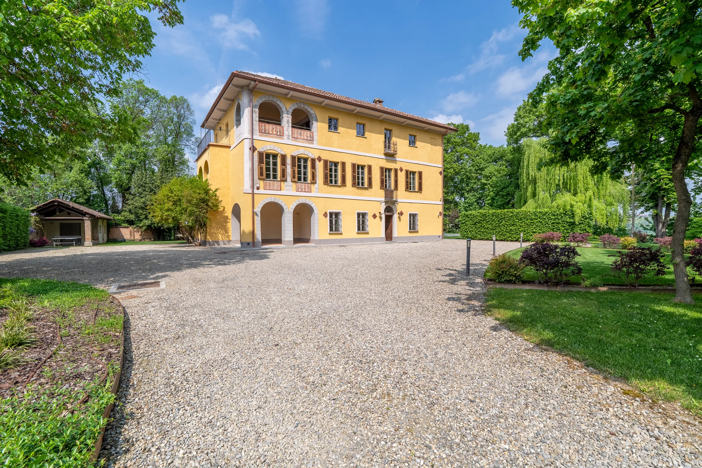 Historic yellow villa facade — Nizza Monferrato, Italy. Photography by Yunes Calore.