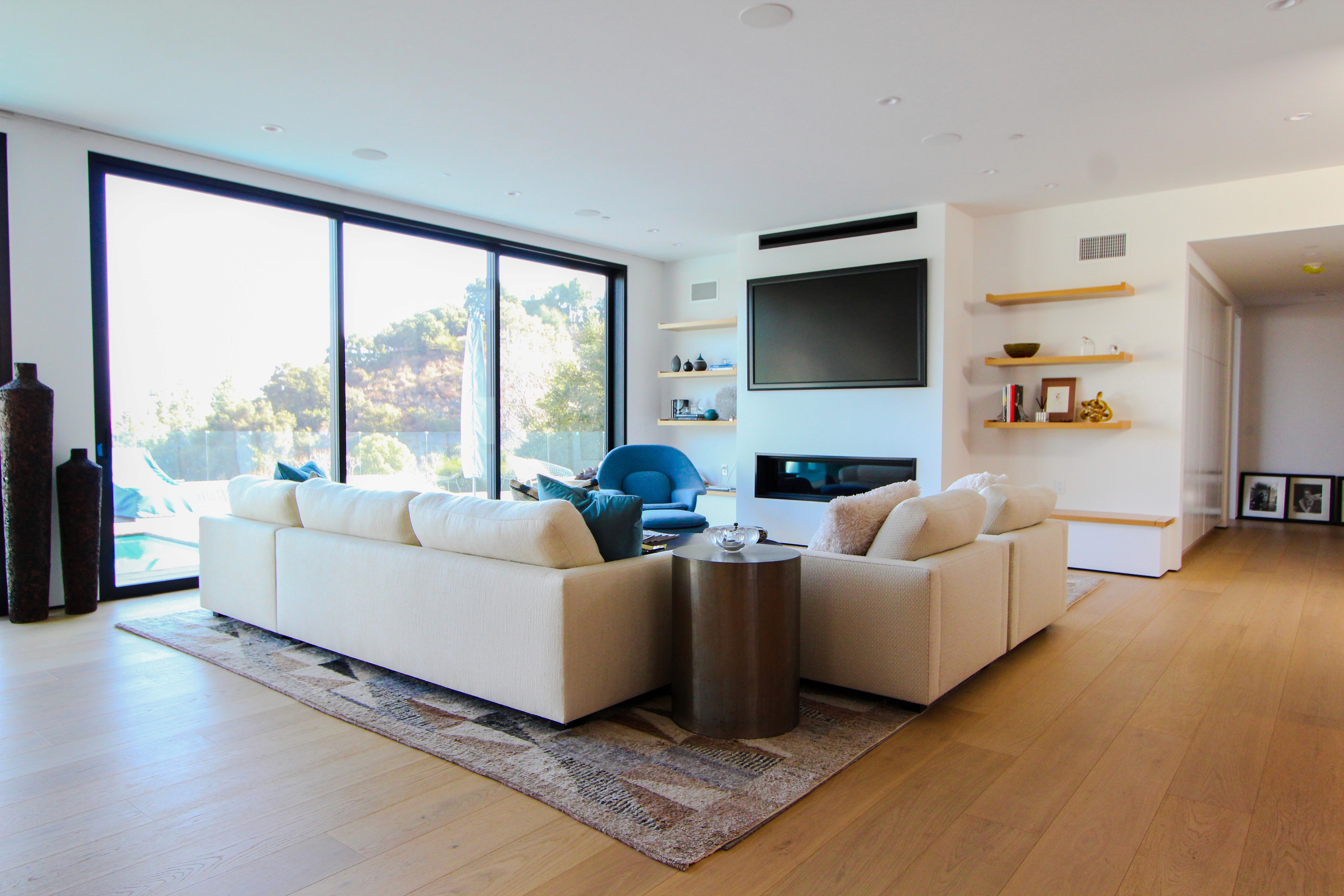 Living room featuring large glass doors opening to the outdoors.