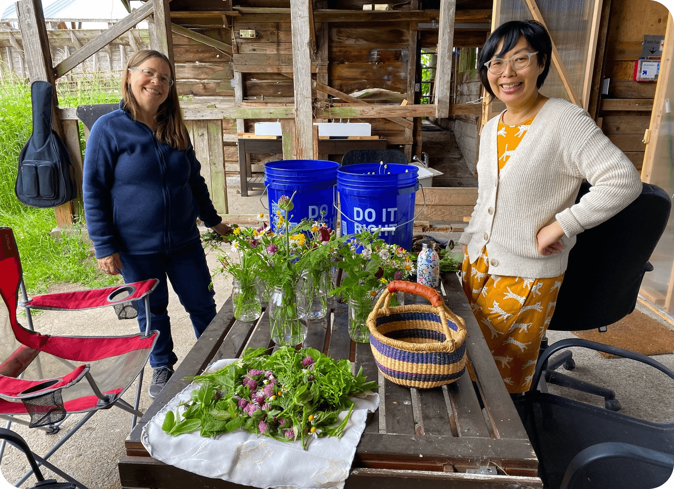 Community members preparing freshly harvested flowers and herbs together.