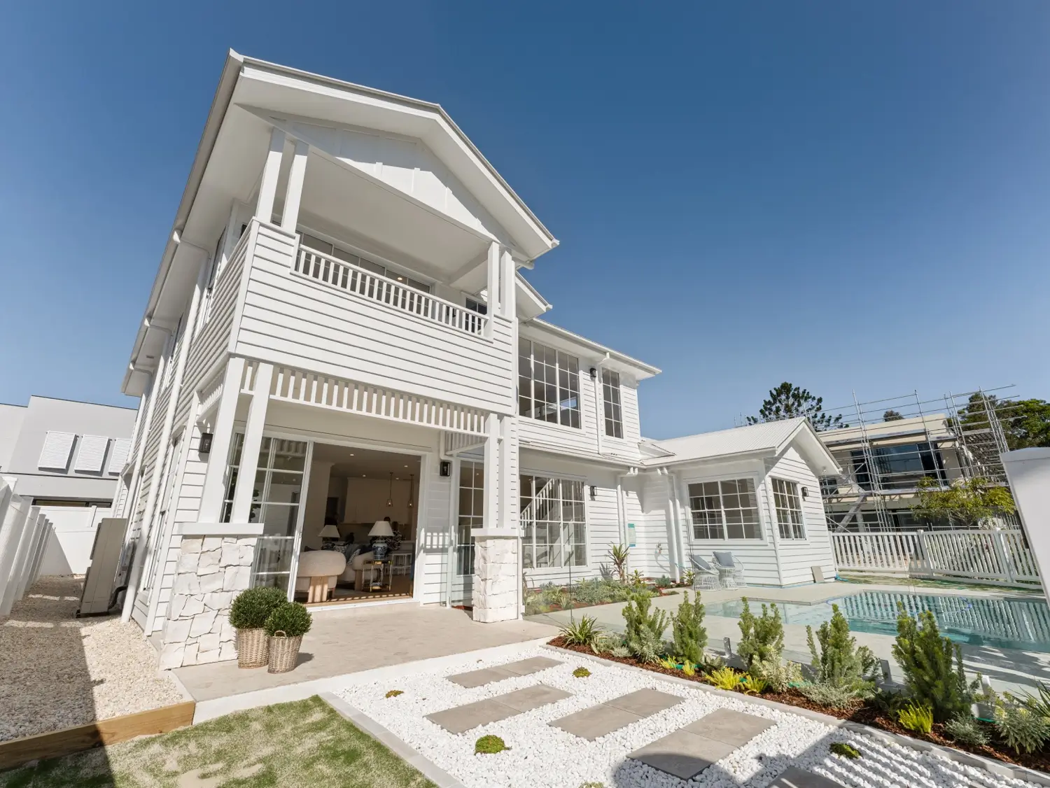 A Hamptons-inspired modern two storey home in Brisbane with weatherboard cladding and gabled roofline