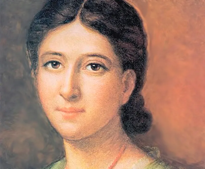 four boys laughing and sitting on grass during daytime