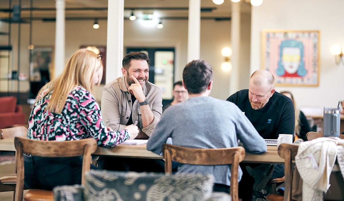 4 people sat in a sound recording studio