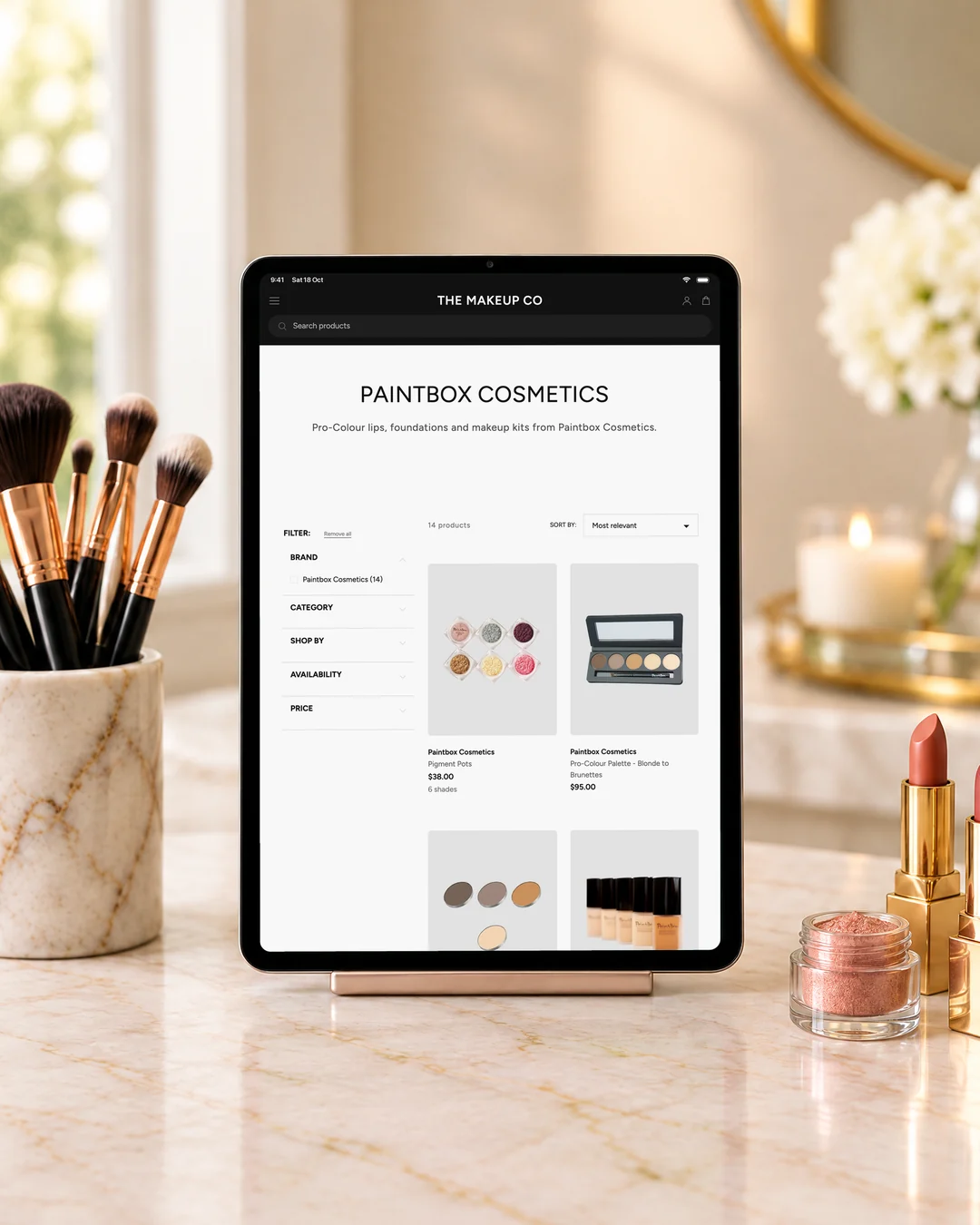 The Makeup Co's Paintbox Cosmetics page on an iPad on a marble vanity.