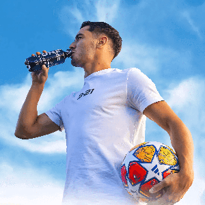 Woman in blue sportswear stretching in lunge pose on dark blue background