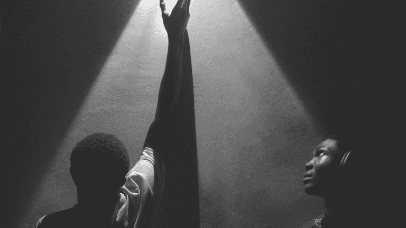 A cozy scene with warm sunlight casting stripes, featuring a potted plant and soft towels on a window sill.