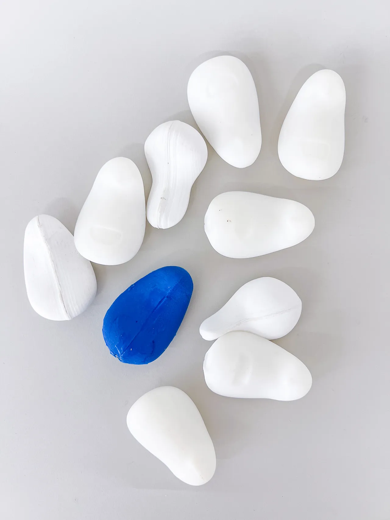 White and blue ergonomic form prototypes arranged for product refinement