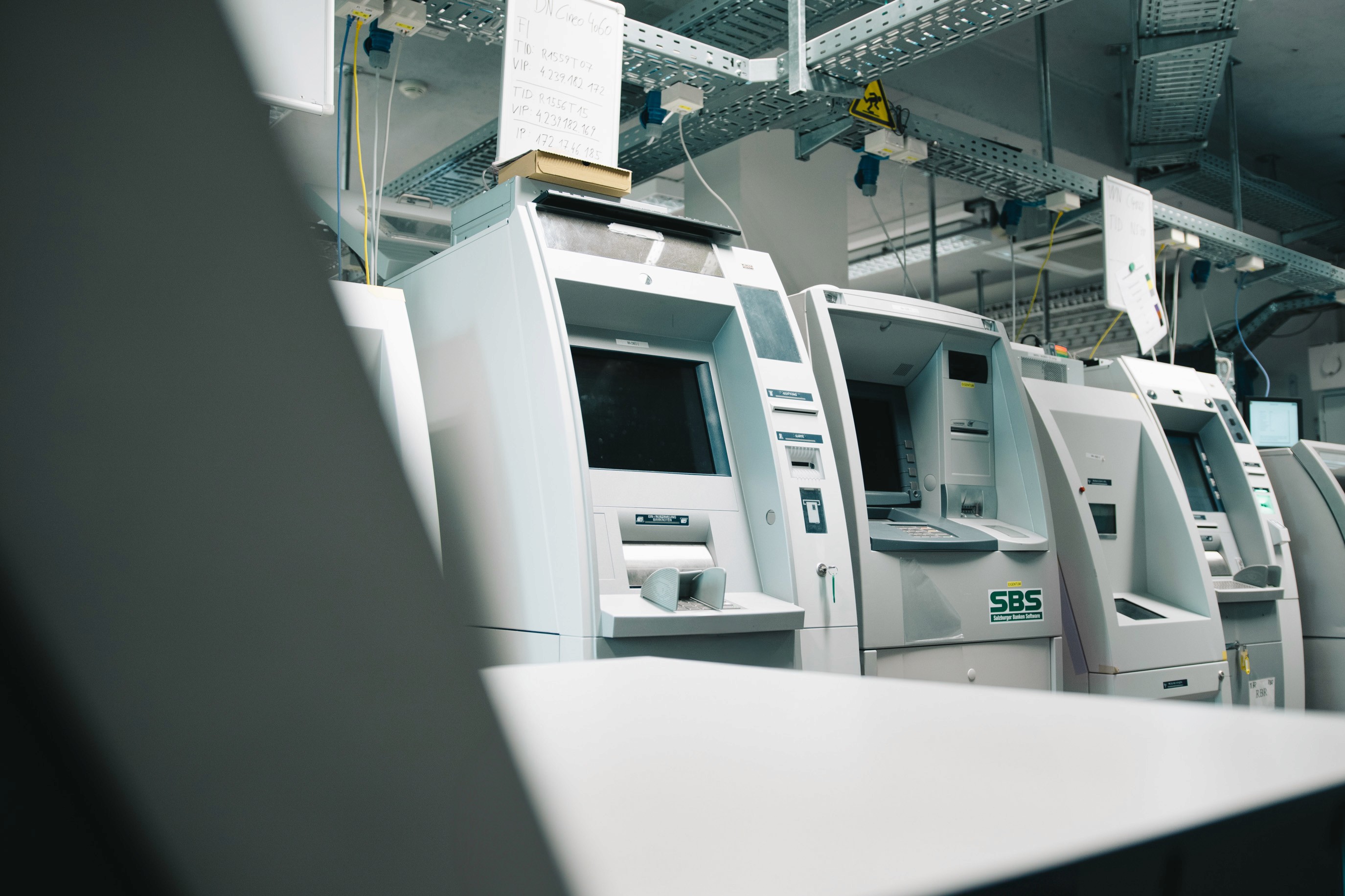 A modern, high-tech ATM machine at the center, surrounded by glowing interconnected lines and nodes representing a vast ATM network, with multiple ATMs connected in a digital abstract space.