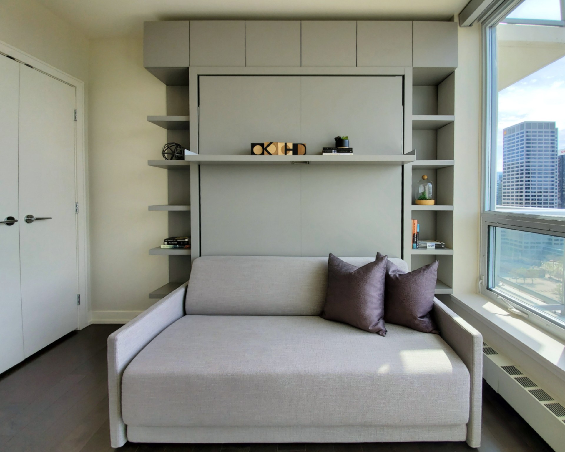 Image of KHD Homes design-build interior with sofa, shelving, and window, showcasing luxury home renovations and layout design.