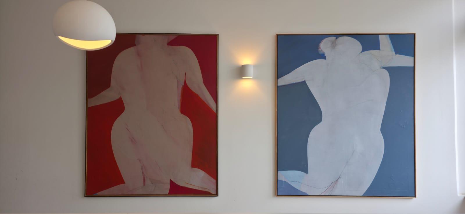 a pregnant woman laying on a bed covered in a blanket