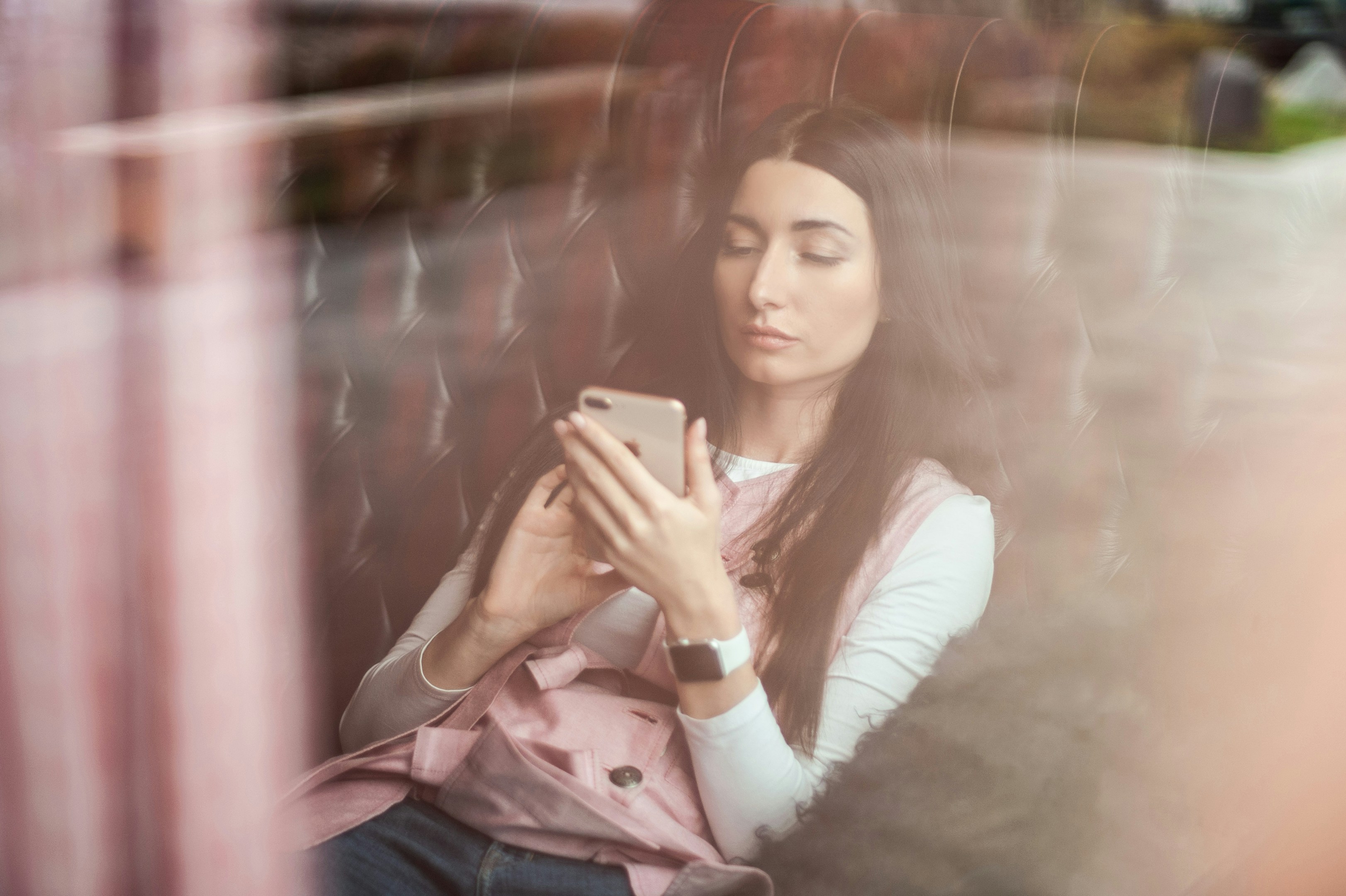 woman looking at her phone - Pregnant Beauty Tips