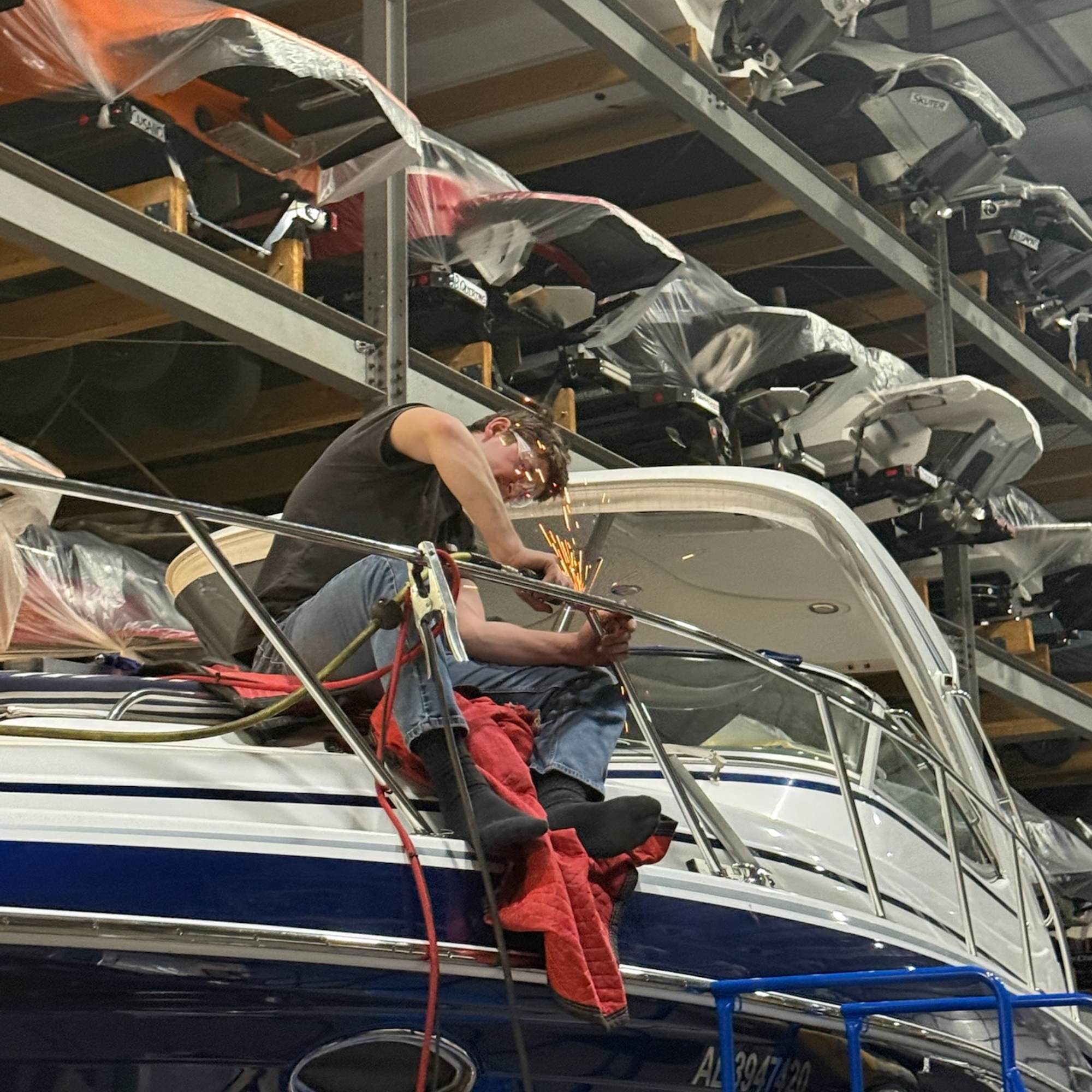 A man working on metal fabrication for a custom repair on a boat in Kelowna BC